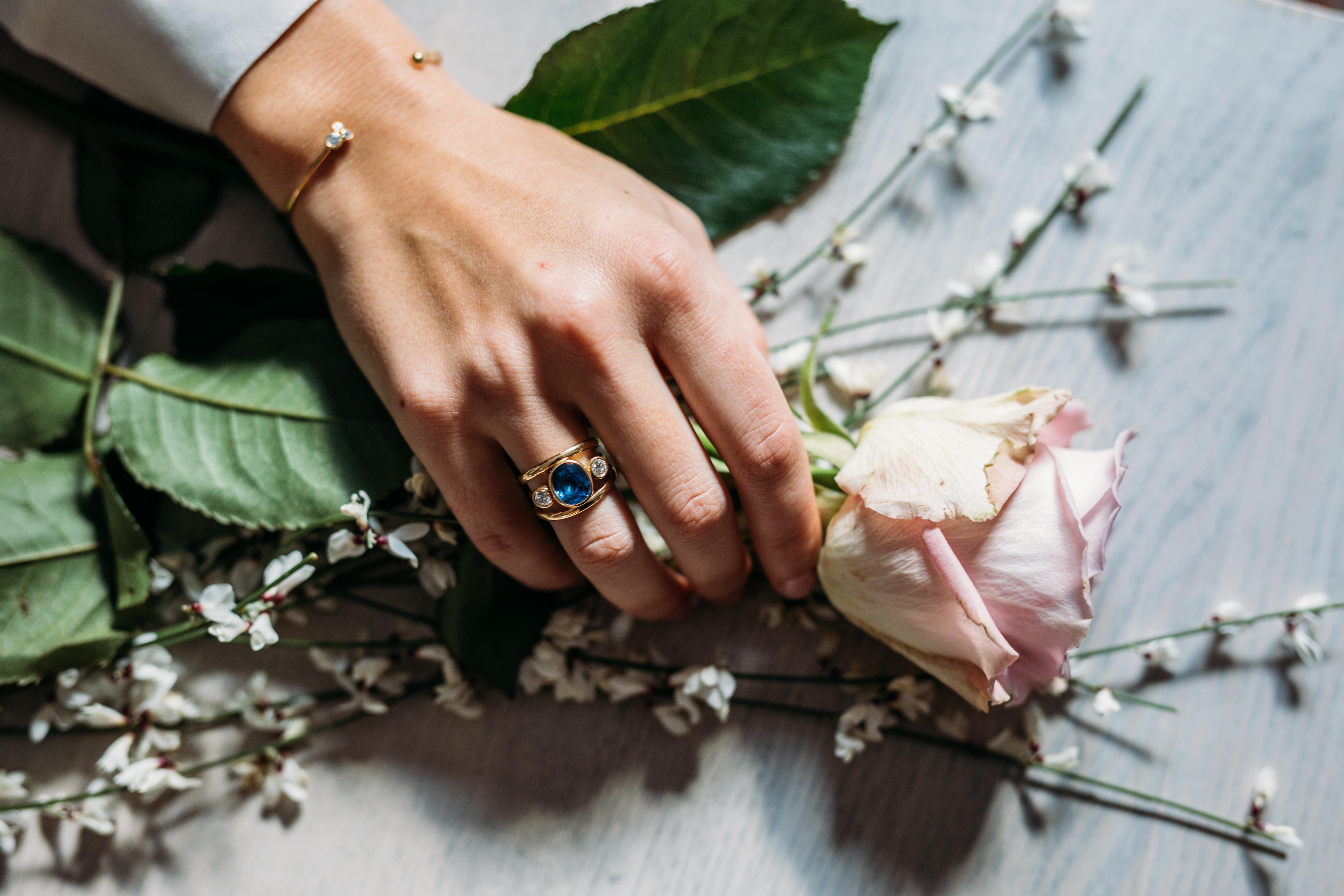 Made to order: A sophisticated and elegant cocktail ring a beautiful and vibrant corn flower blue, This Sri Lankan Sapphire is set with a Diamond on each side and set in 18 karat yellow gold. 
A statement ring that is comfortable to wear as not set