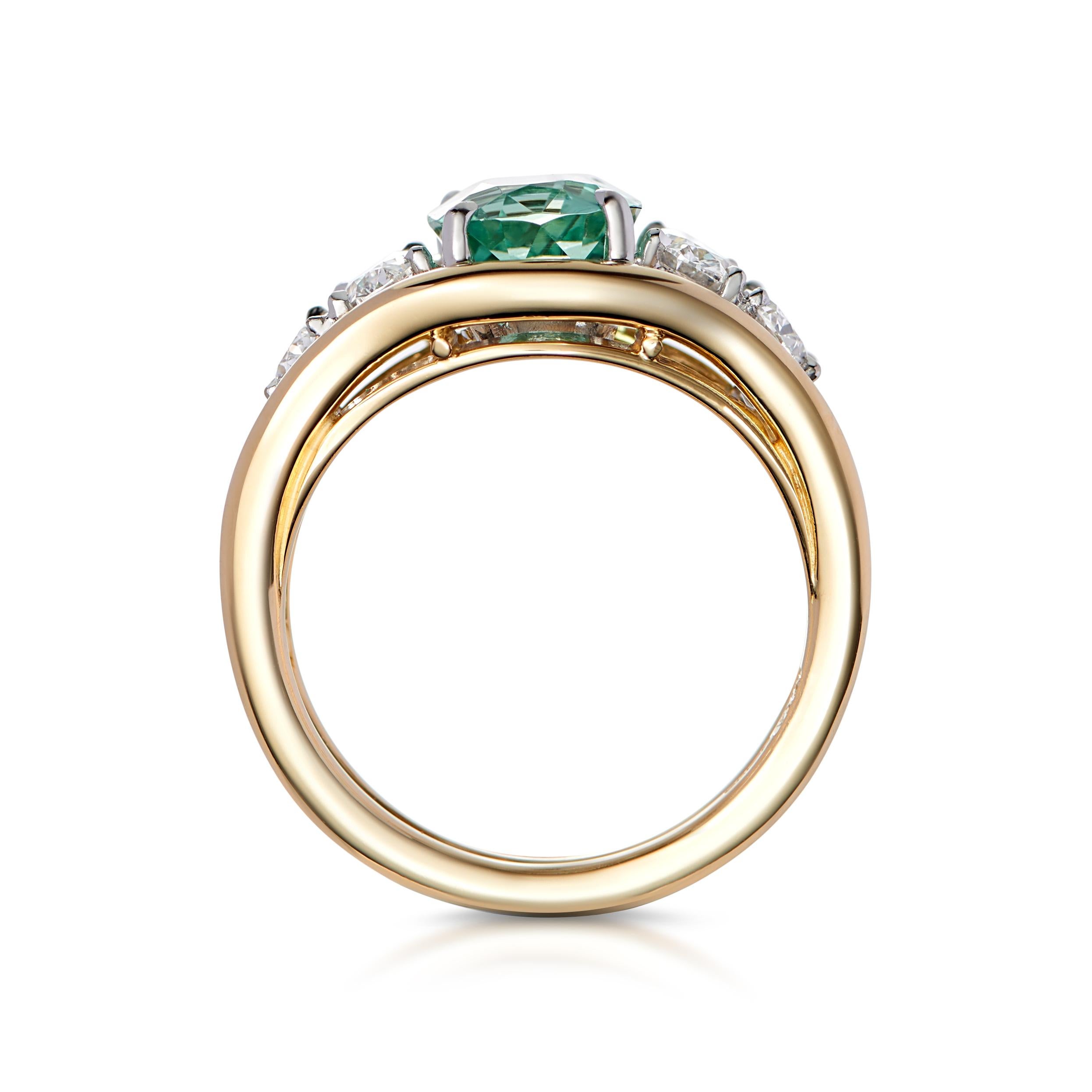 A spectacular Green Tourmaline set with 4 oval cut and white diamonds. This unique, one-of-a-kind statement ring is handmade in London in historic jewelry quarter, Hatton Garden. 

Tourmaline: 2ct
Diamonds: 0.80ct 
Karat: 18k yellow gold with white