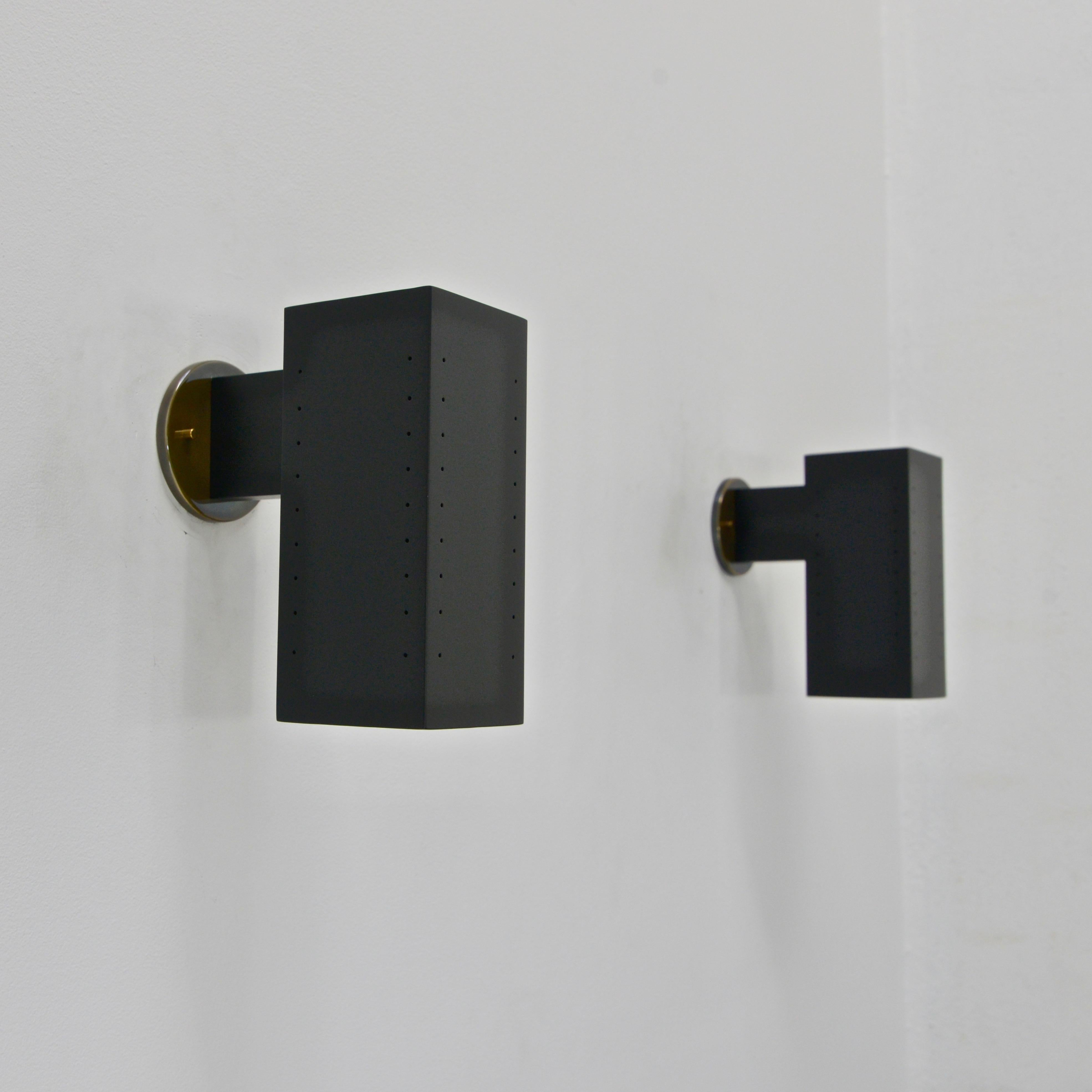 Parte de la colección contemporánea de Lumfardo Luminaires, el aplique de exterior MinLUlith es una versión más pequeña de nuestro aplique de exterior rectangular perforado en aluminio pintado de negro y latón. Lámpara con (1) casquillo E26 de base