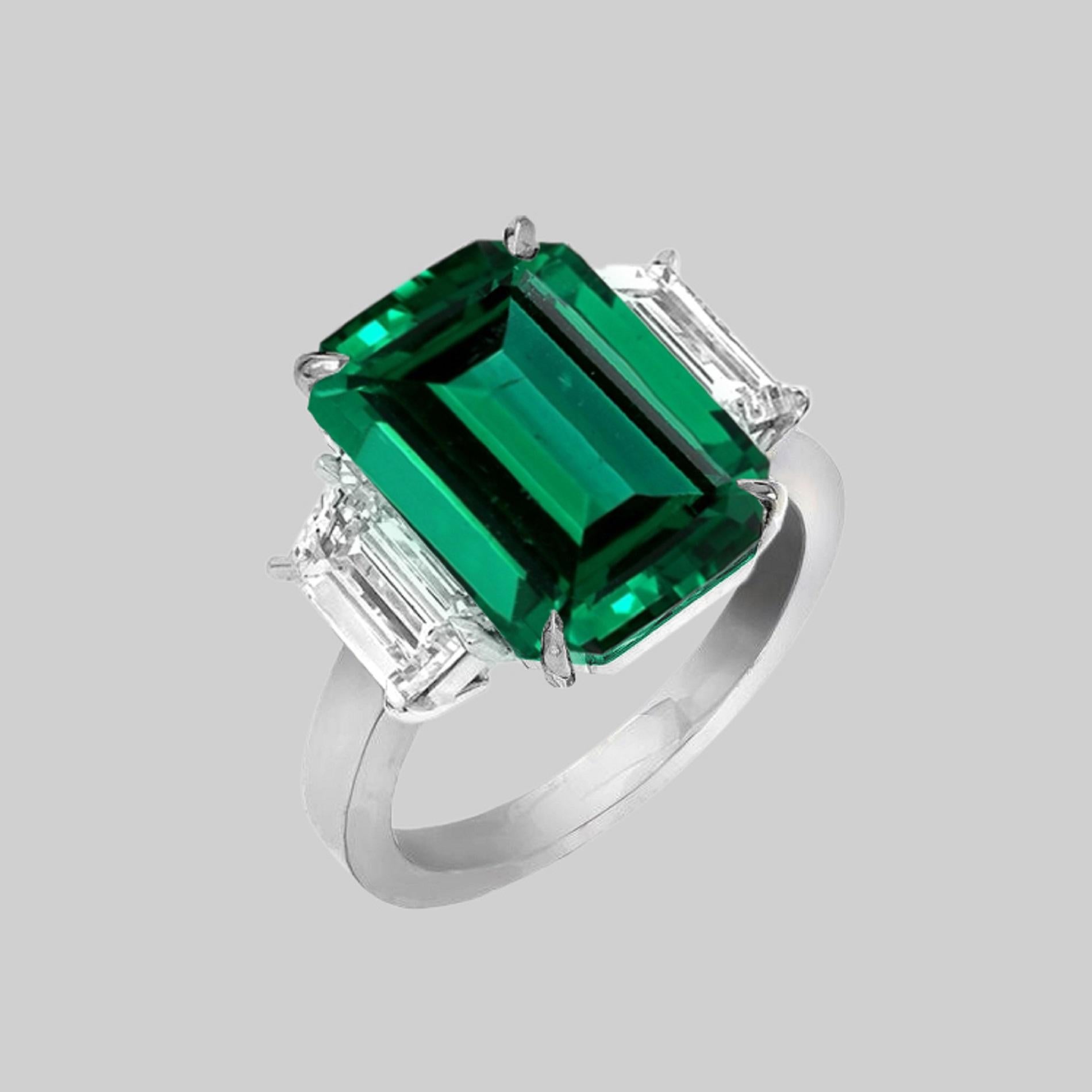 An exquisite GRS certified 6 Carat Green Emerald Ring with two side trapezoid diamonds set in solid platinum 

Also the side trapezoids are GIA certified 

The emerald has been certified as vivid green with minor oil

