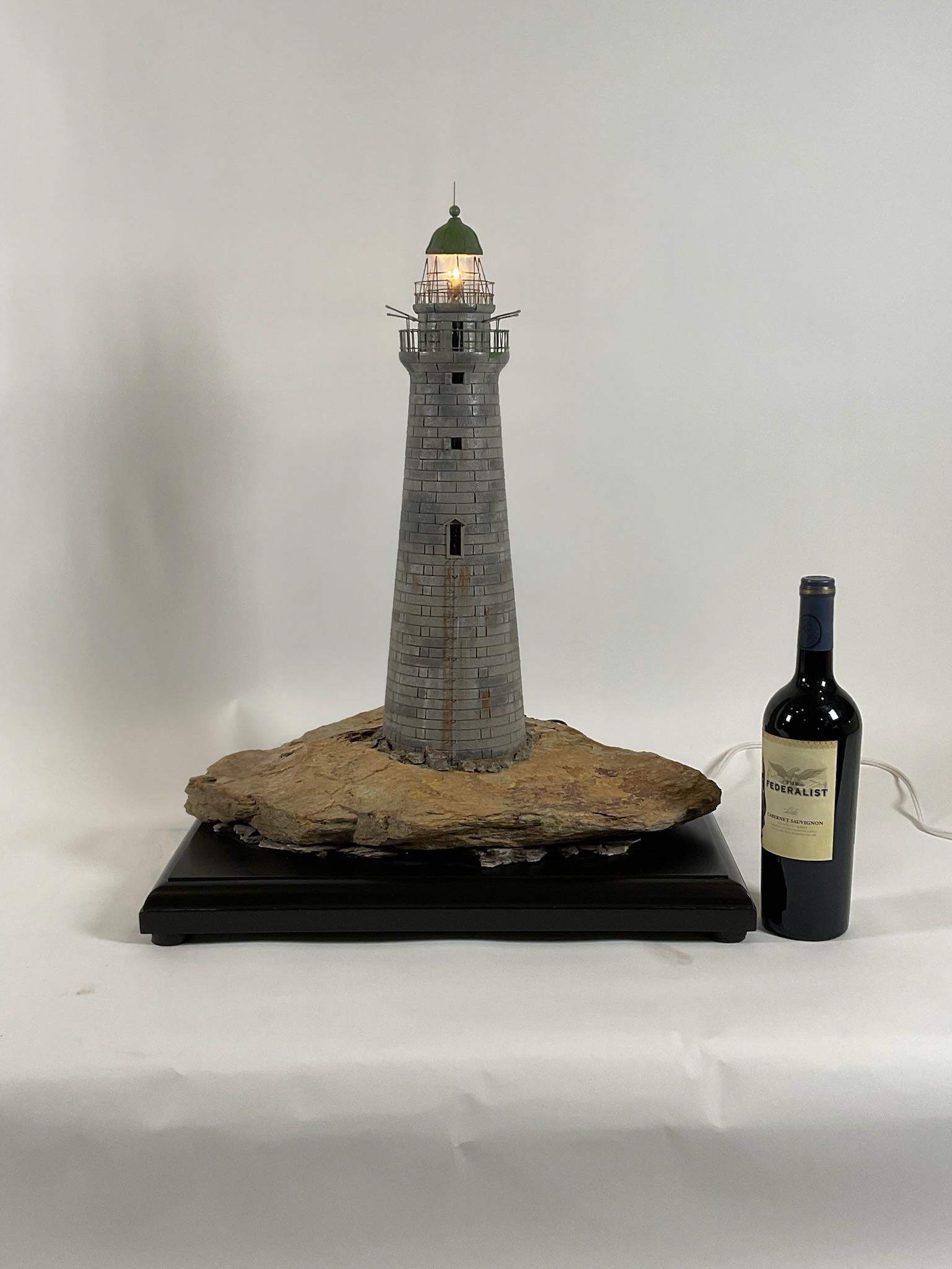 Minots light lighthouse model set onto a ledge. Exceptional model with all stones shown in the proper scale. The top has railings, boat davits, lantern room, spire, etc.

From 1851 to 1860 a lightship replaced the tower at Minots Ledge. Work on