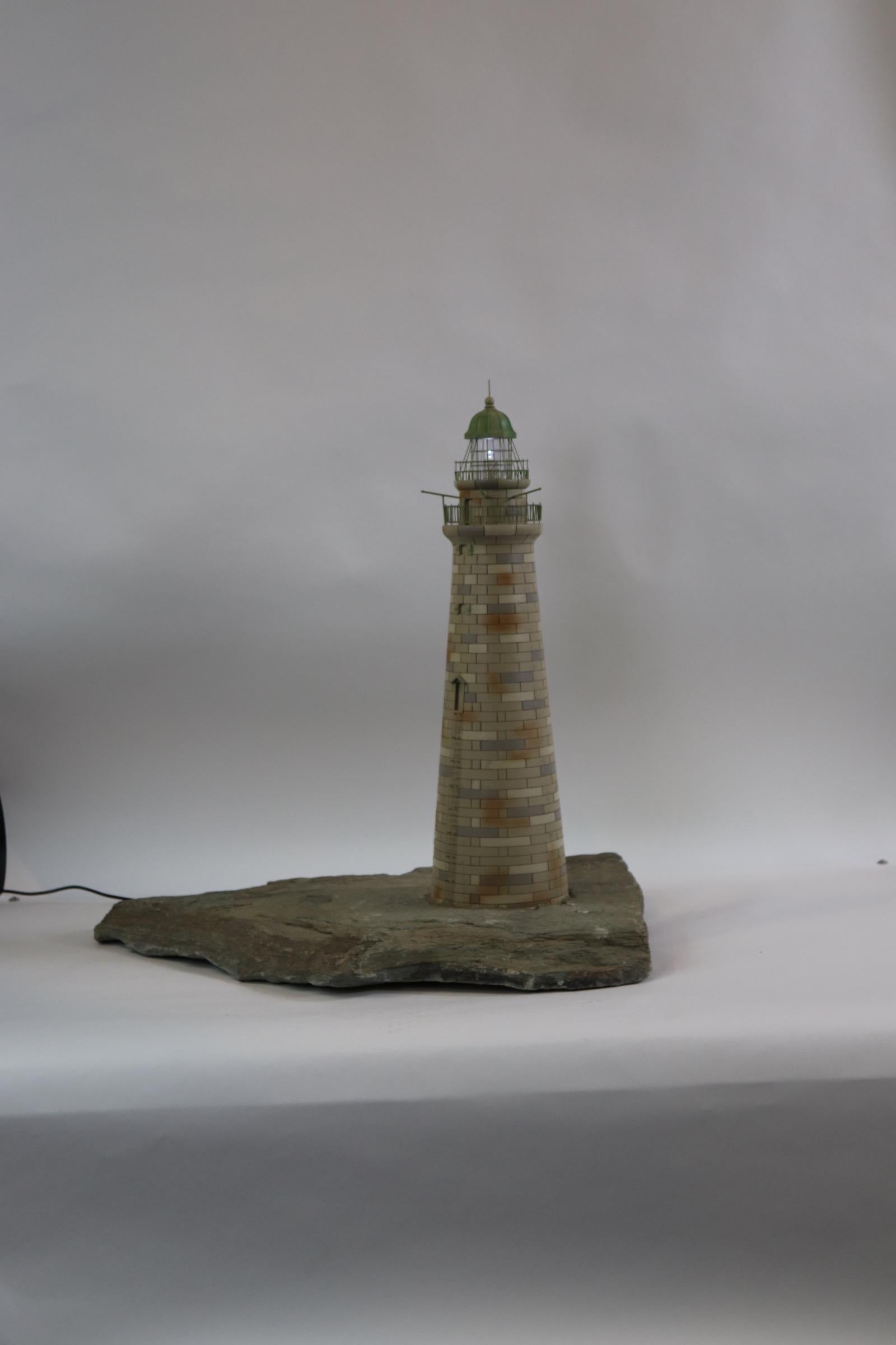 Minots light lighthouse model showing incredible workmanship. This model is very well built and scaled quite well showing the same number of stones as the actual. Mounted onto a piece of thick stone. Fitted with a blinking light in the light room.