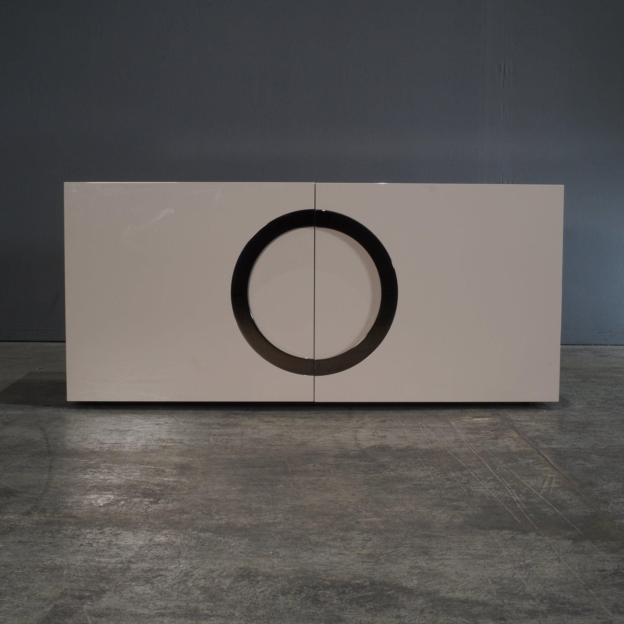 The Minotti Archipenko Cream Sideboard by Rodolfo Dordoni is a sleek embodiment of contemporary luxury and Italian craftsmanship. Featuring a minimalist silhouette, this sideboard is finished in an elegant cream lacquer, offering a refined look that