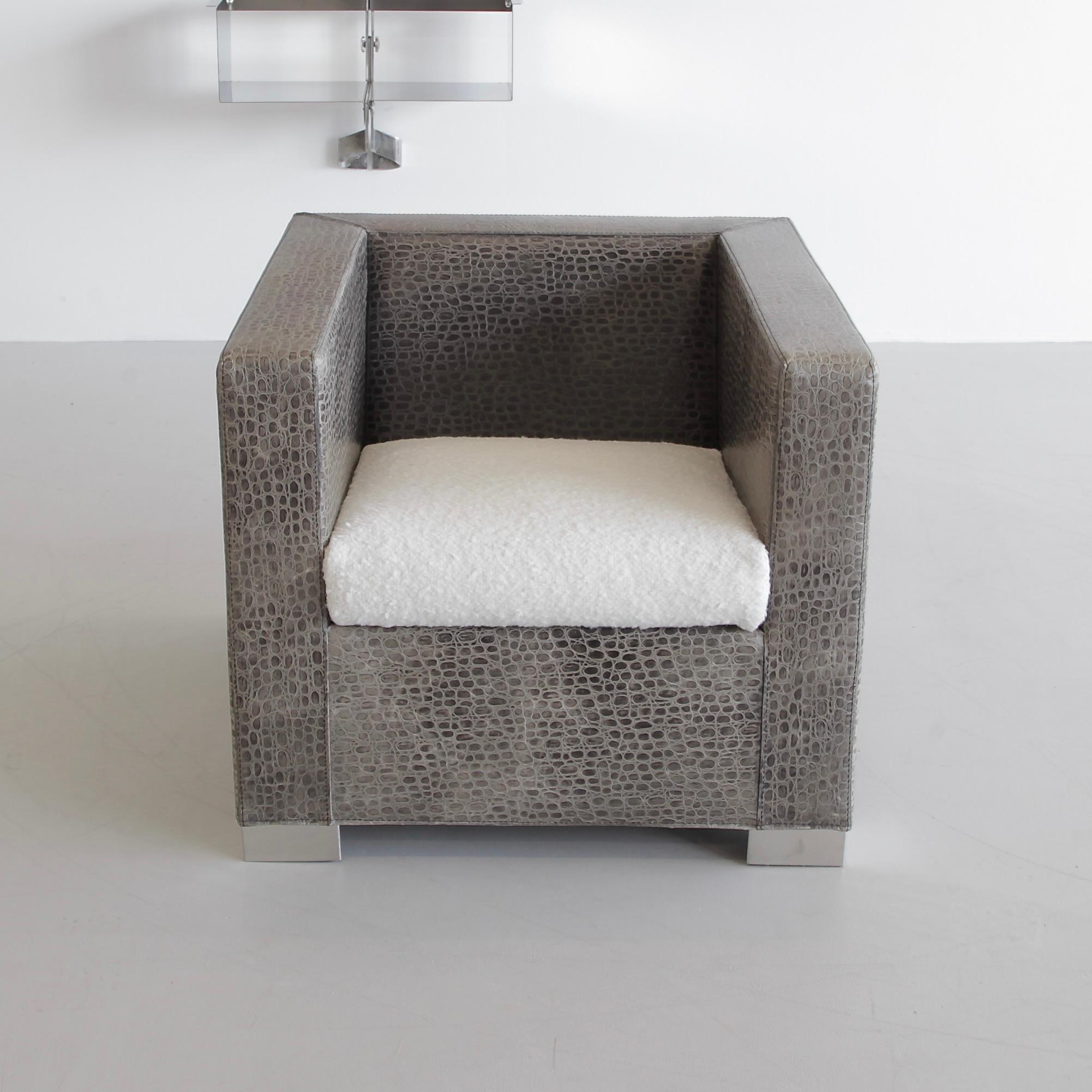 Armchair designed by Rodolfo Dordoni. Italy, Minotti, 1997.

The cubic armchair from the 'Suitcase' line by Minotti. Upholstered in printed leather with 'reptile look', new boucle covered cushion and chrome base.