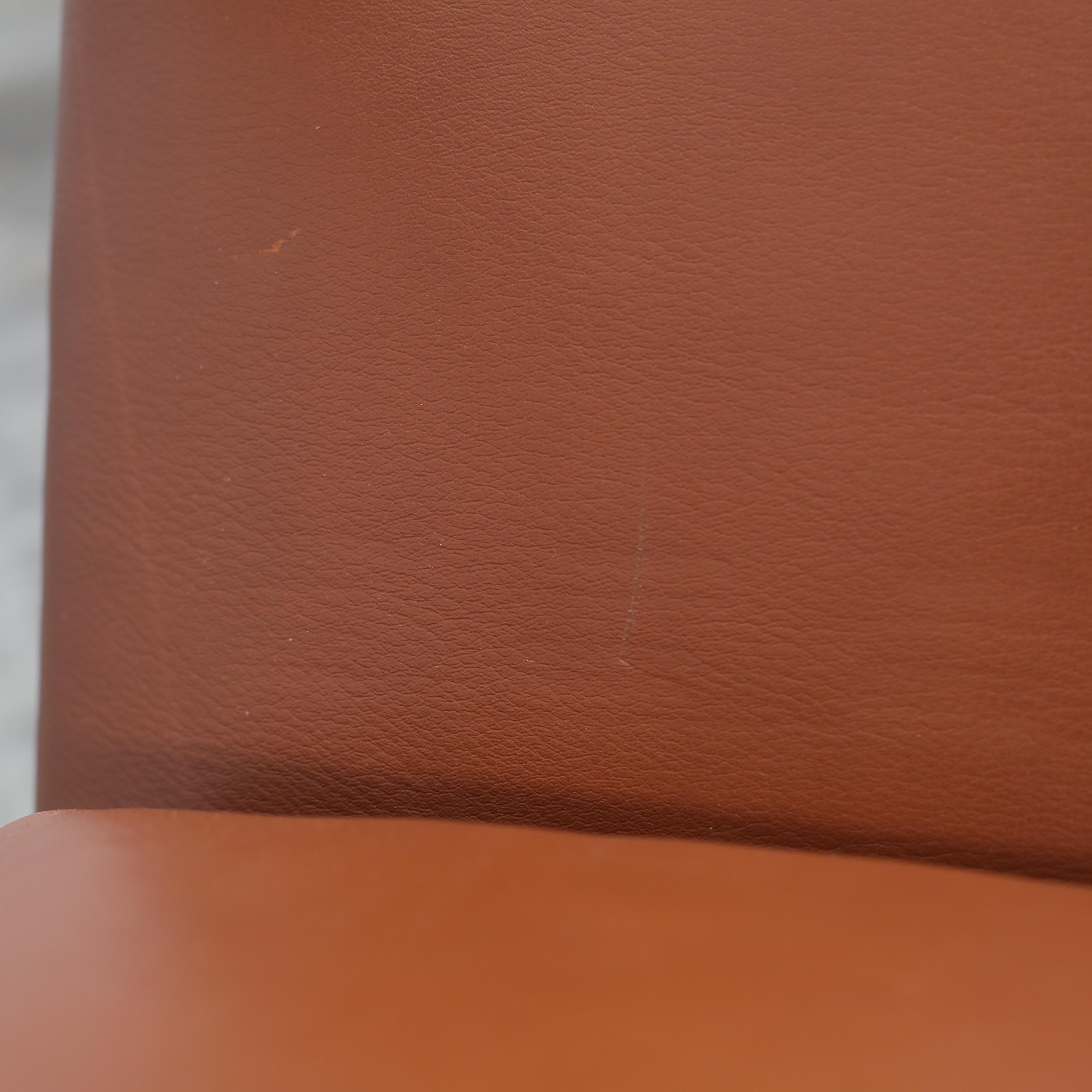 Introducing the Atlan Armchair by Rodolfo Dordoni for Minotti - a contemporary design of refined comfort. This sculptural armchair features a gracefully slanted backrest and integrated armrests, offering exceptional support and style. Upholstered in