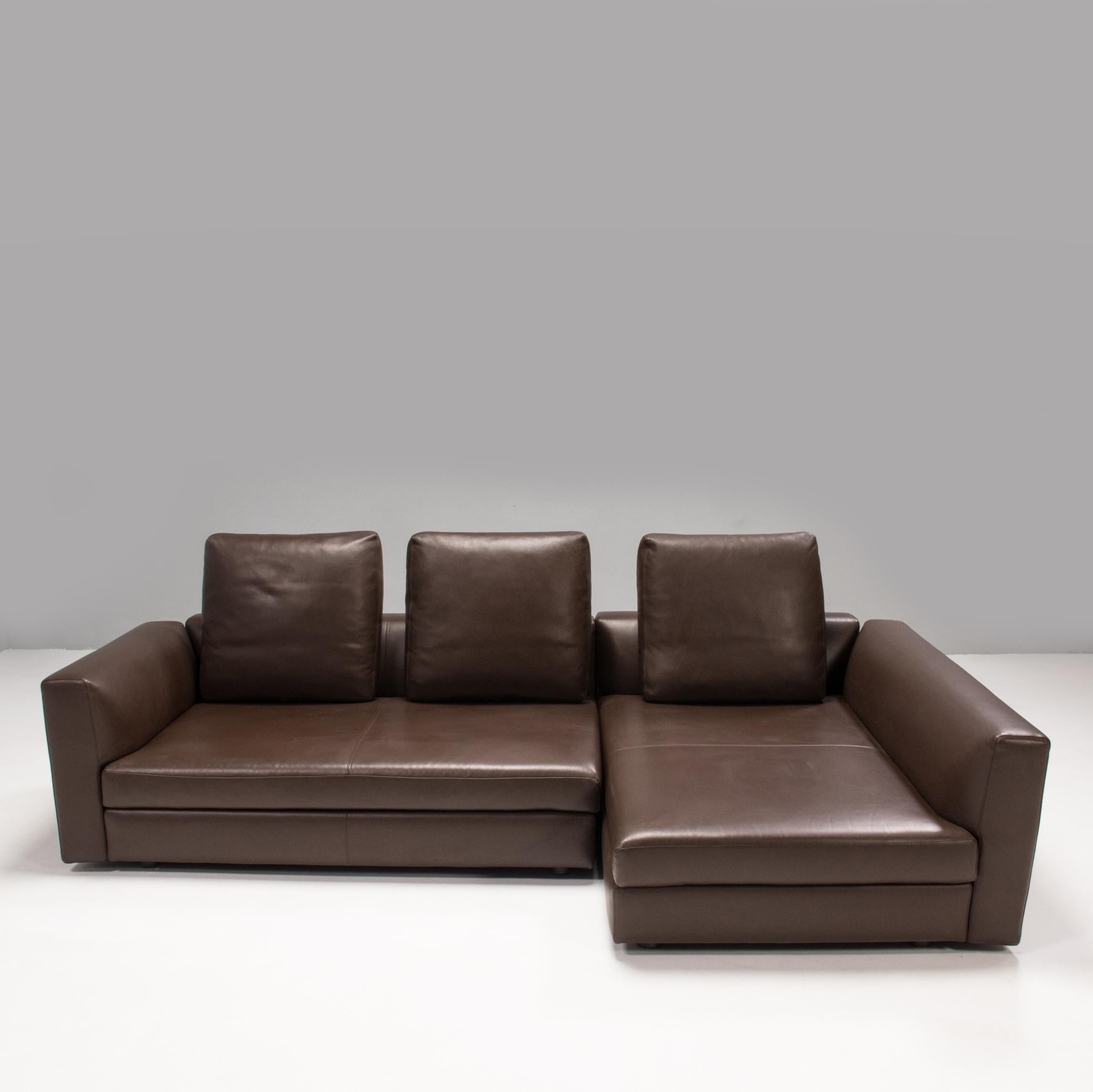 Designed and manufactured by Minotti, this corner sofa comprises of two separate sections.

Fully upholstered in brown leather, the sofa features integrated back cushions and armrests, with a separate seat cushion on each unit.

Three additional