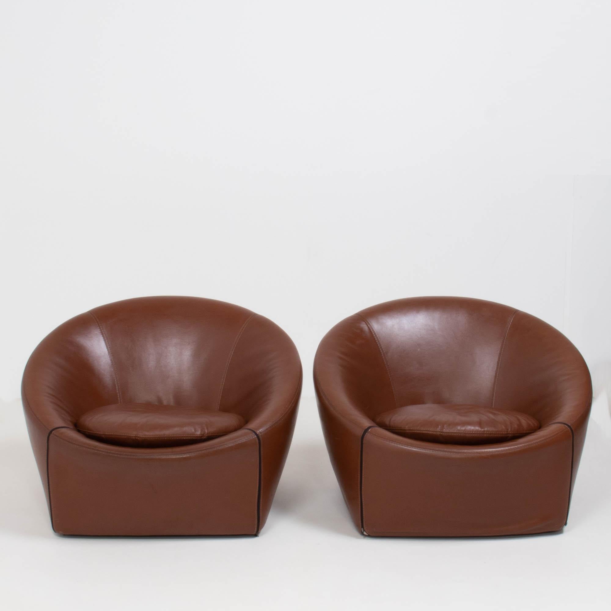 Designed by Gordon Guillaumier for Minotti in 2005, the capri chair perfectly balances style and comfort.

The tub style chairs are fully upholstered in brown leather and the covers can be removed with the exposed zip detailing.

A separate