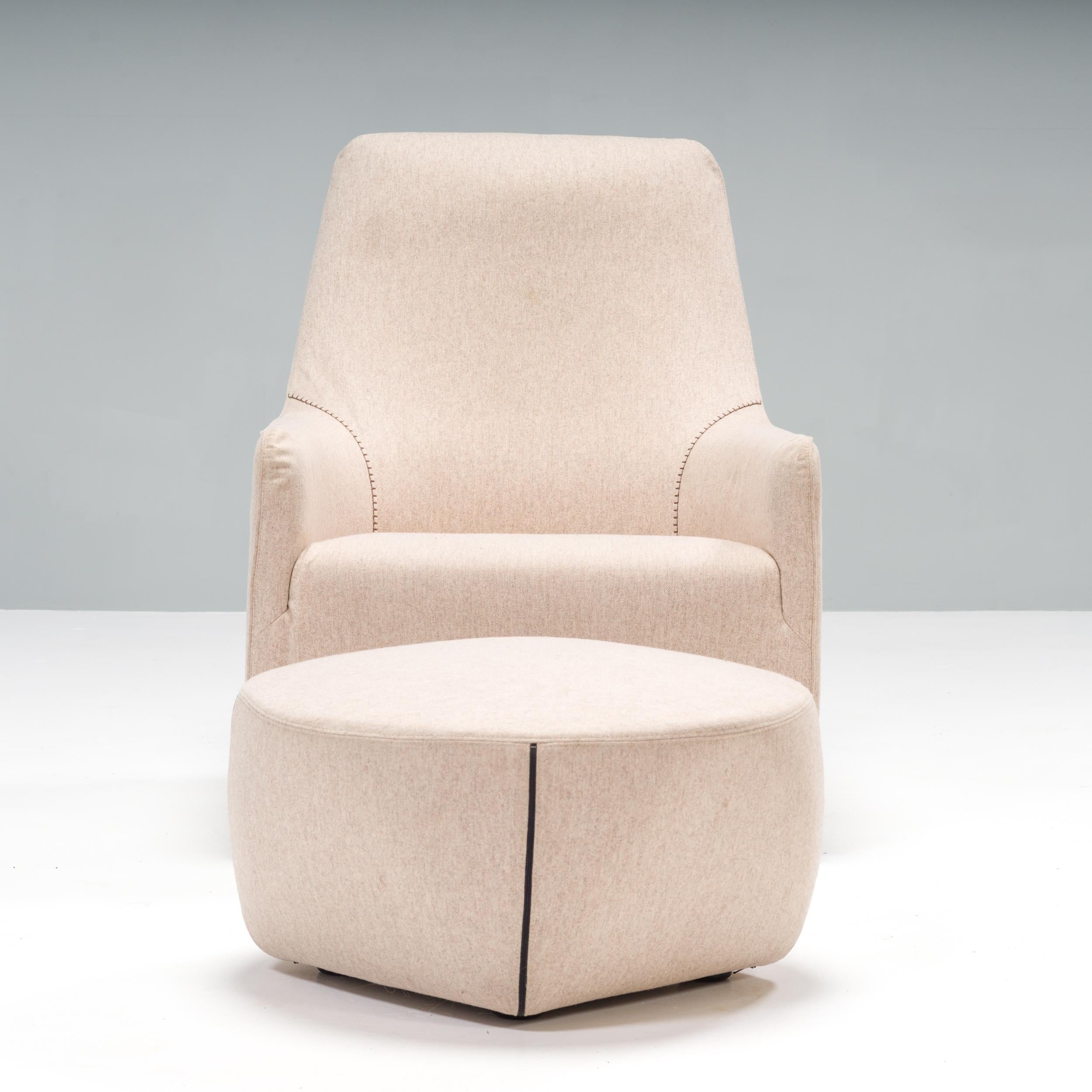 Designed by Rodolfo Dordoni for Minotti in 2005, the Portofino collection offers a modern update on the classic armchair styles.

With an extended backrest, this French bergère style chair is fully upholstered in grey fabric and has a fixed