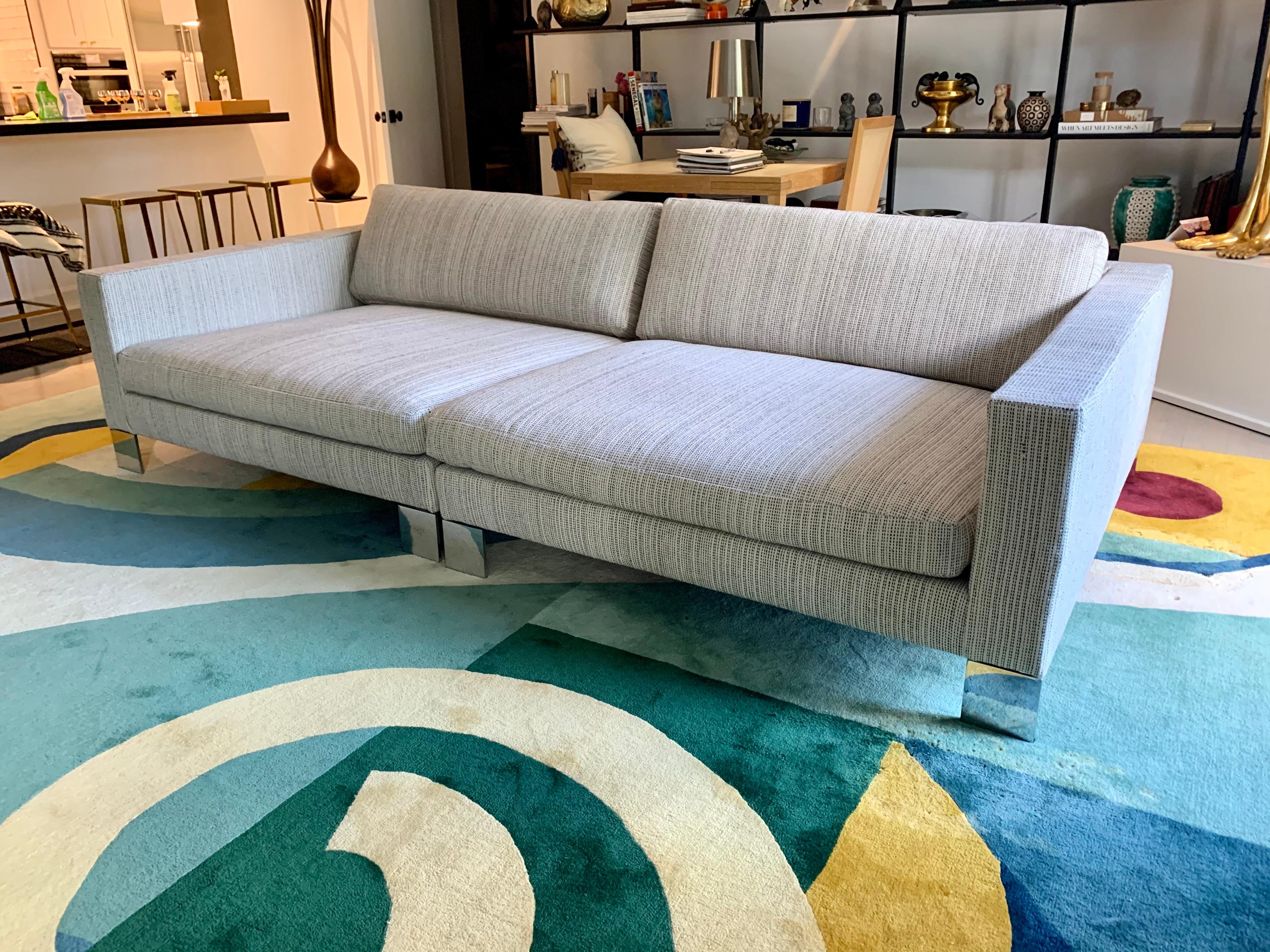 This lovely large square designed Minotti sofa sectional in two pieces can easily be put together for a deep lounge space or apart for individual seating, circa 1990s. Retains original labels and reupholstered in a heavy weave cotton rag style