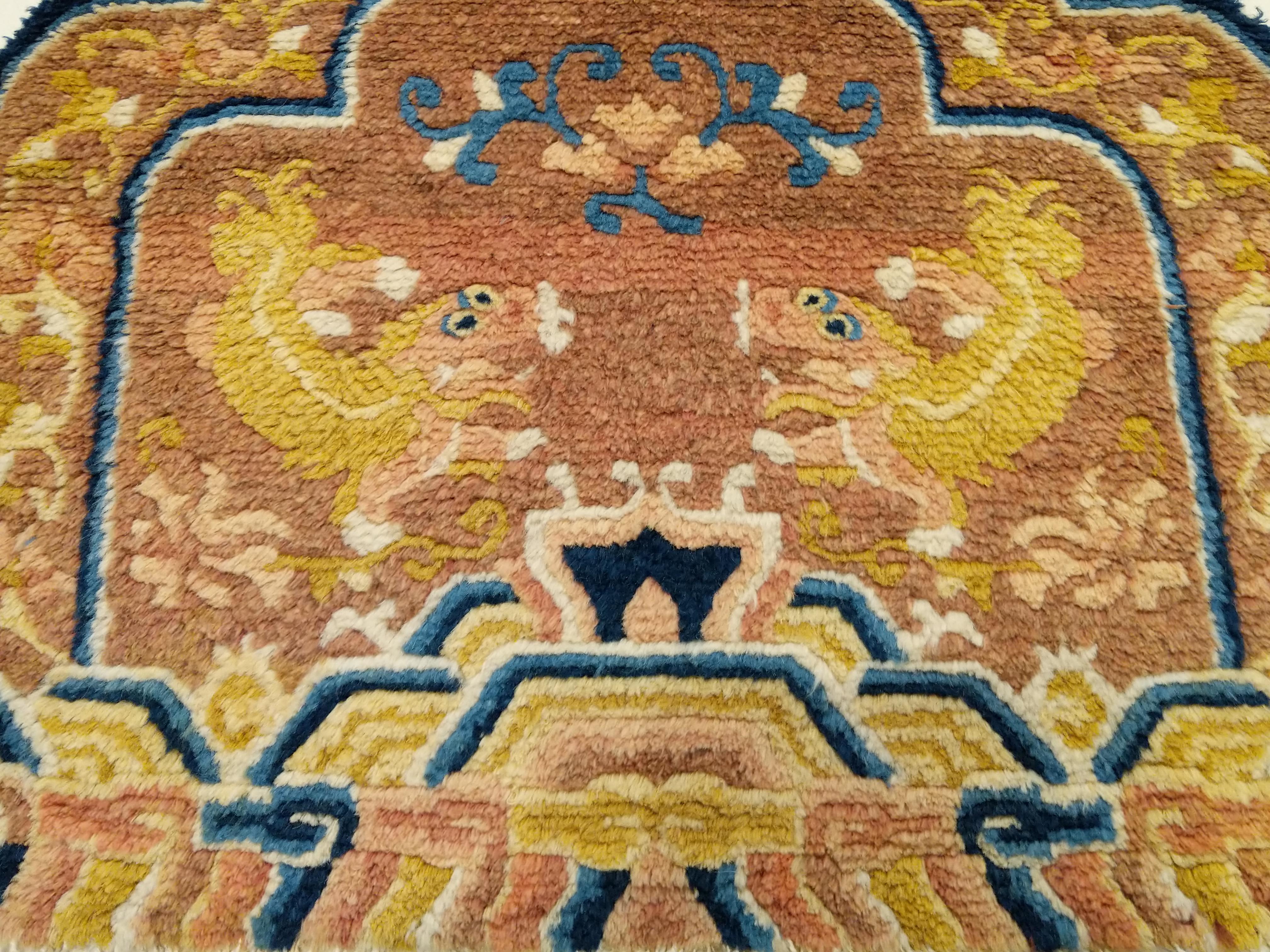 A rare example of Ningxia Chinese throne back cover of Imperial quality in pristine condition. A true gem distinguished by a plethora of shades of red, blue and yellow depicting a pair of superbly drawn lion dogs, auspicious symbols of protection