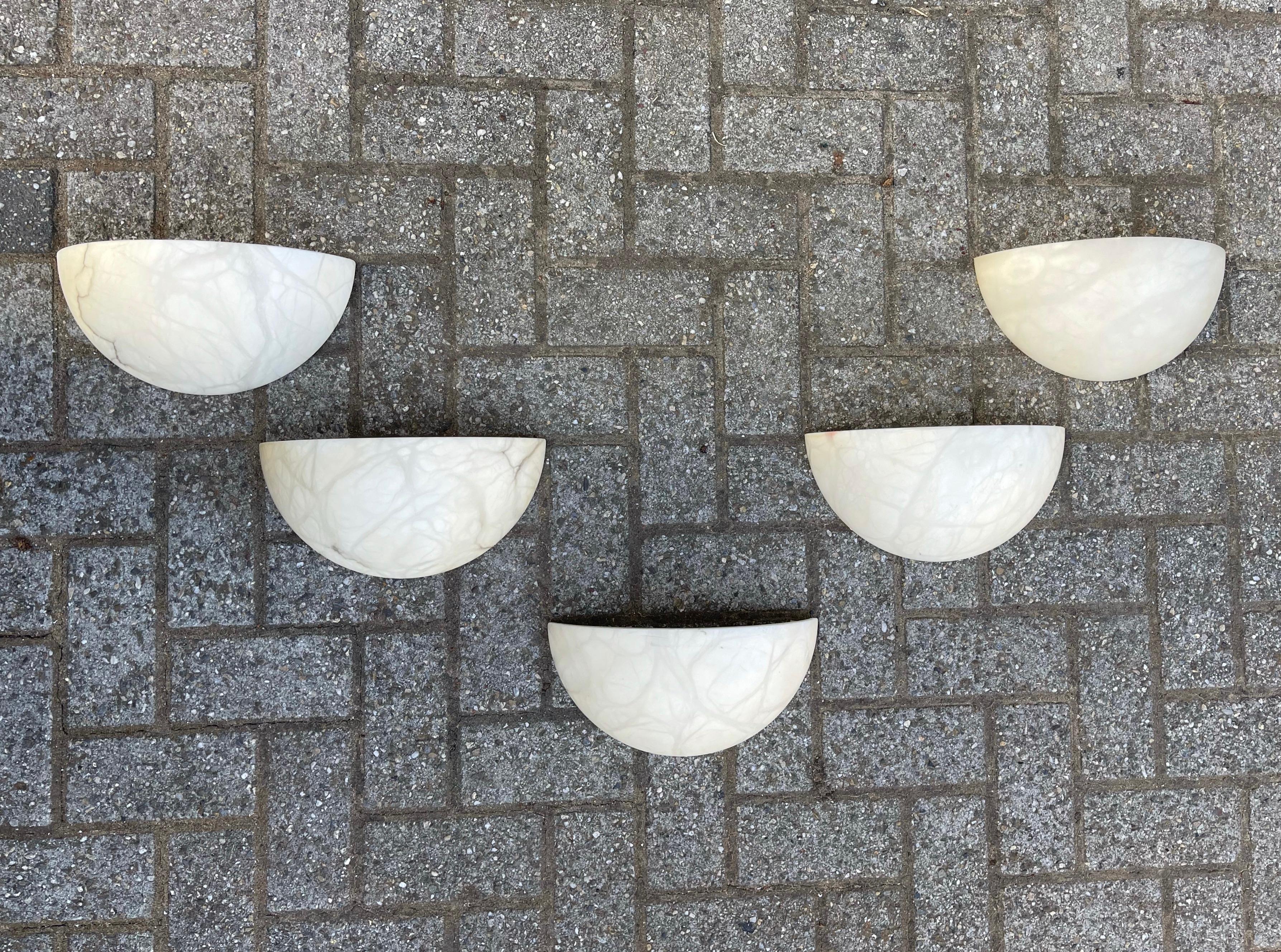 Timeless set of 5 alabaster wall lamps.

These good size and great design wall sconces with warm light creating qualities are all in superb condition. There is something about the look and feel of these alabaster shades (with or without the light