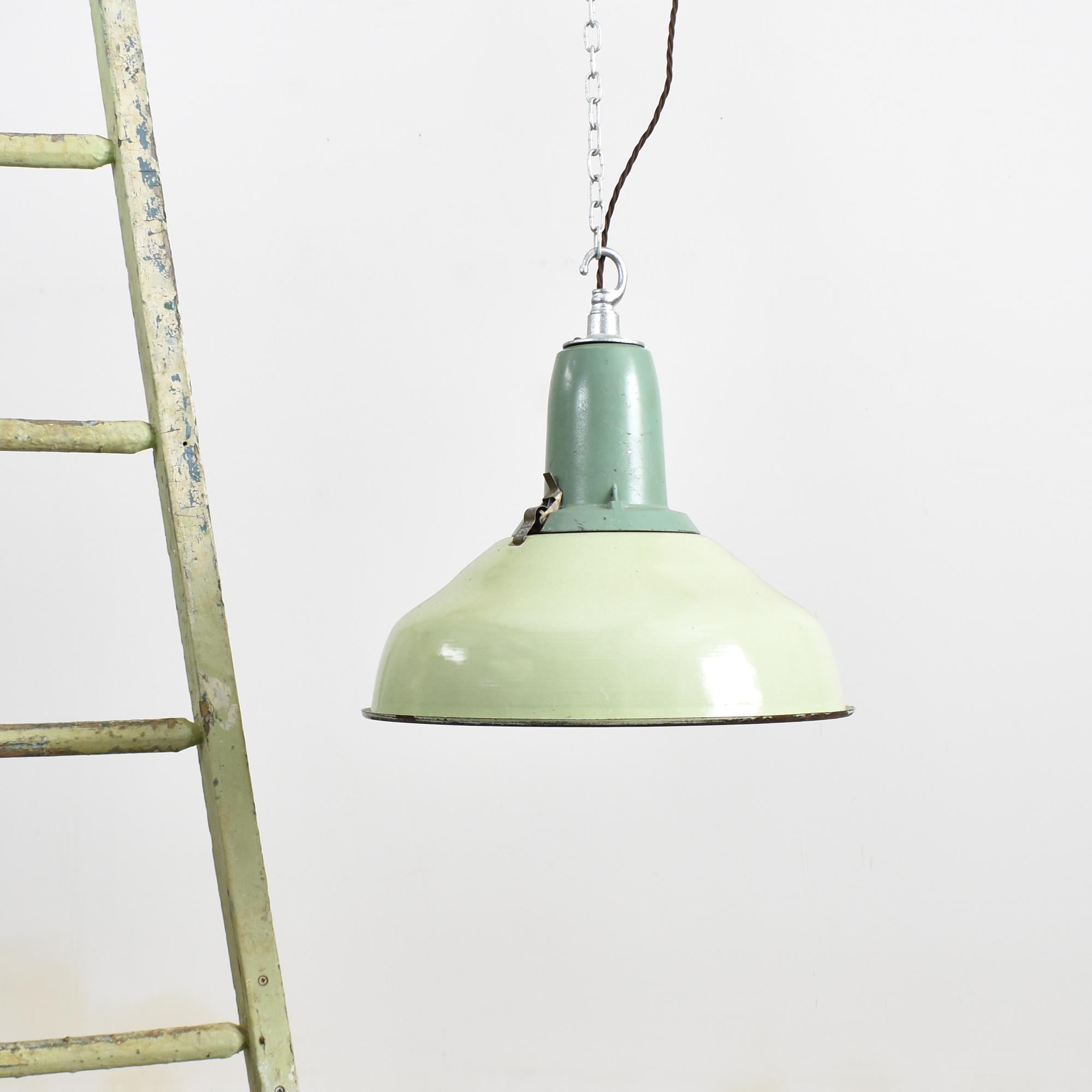 Mint Green Industrial Pendant Light

A stunning industrial factory light shade salvaged from a printing factory in the Ukraine. The light consists of two parts, a large enamelled spun metal shade pale green in colour with a black rim and a darker