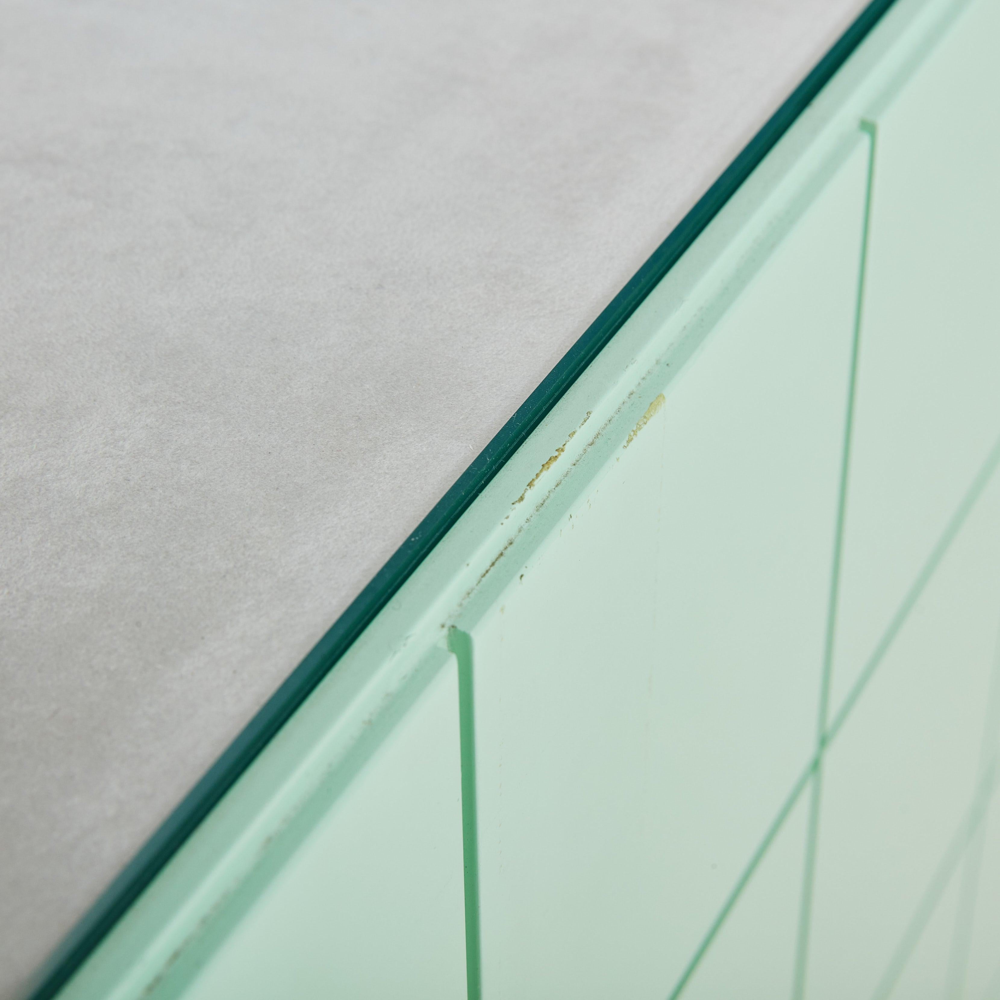 A captivating Postmodern storage cabinet attributed to Italian designer Alessandro Mendini for Alessi in the 1980s. The cube silhouette is composed of smooth lacquered wood in a soft, mint green hue and features an etched square patten throughout-