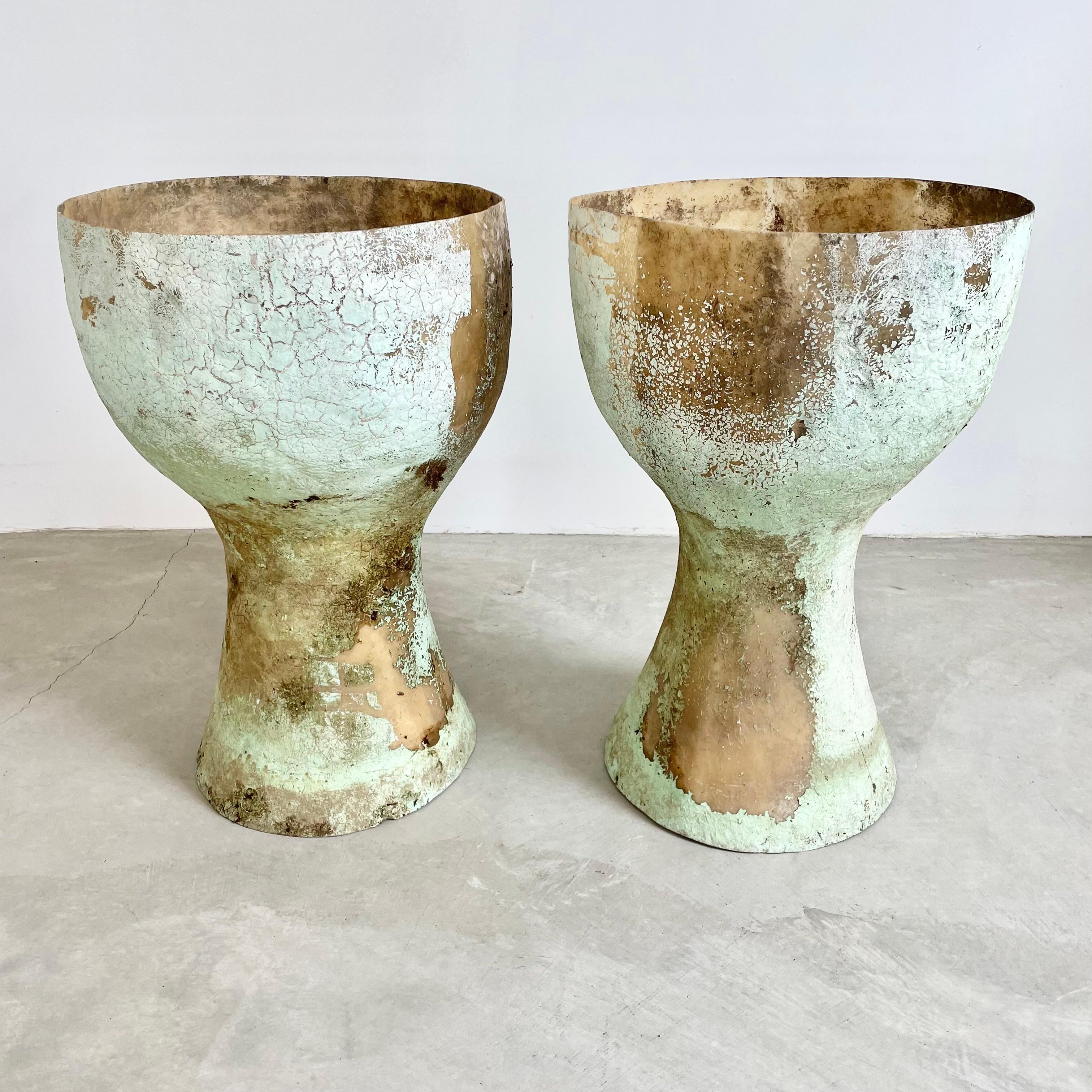 Gorgeous set of monumental fiberglass vases from Belgium, circa 1960s. Both vases are painted a mint green and have a different but equally unique patina. Amazing presence. Being very light and having no base, these planters are meant for plants to