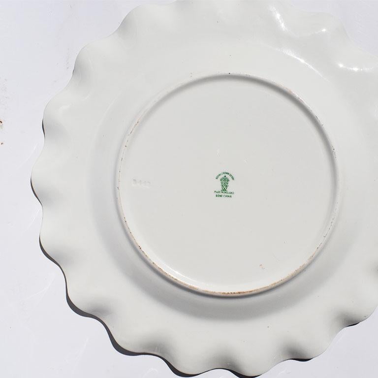 Mint green scalloped edge decorative dinner plate by Royal Crown Derby. A lovely plate to bring color to any table, it features a bright floral motif at the center, and gold trim at the edges and inner circle.

Stamped at bottom in green:
Royal