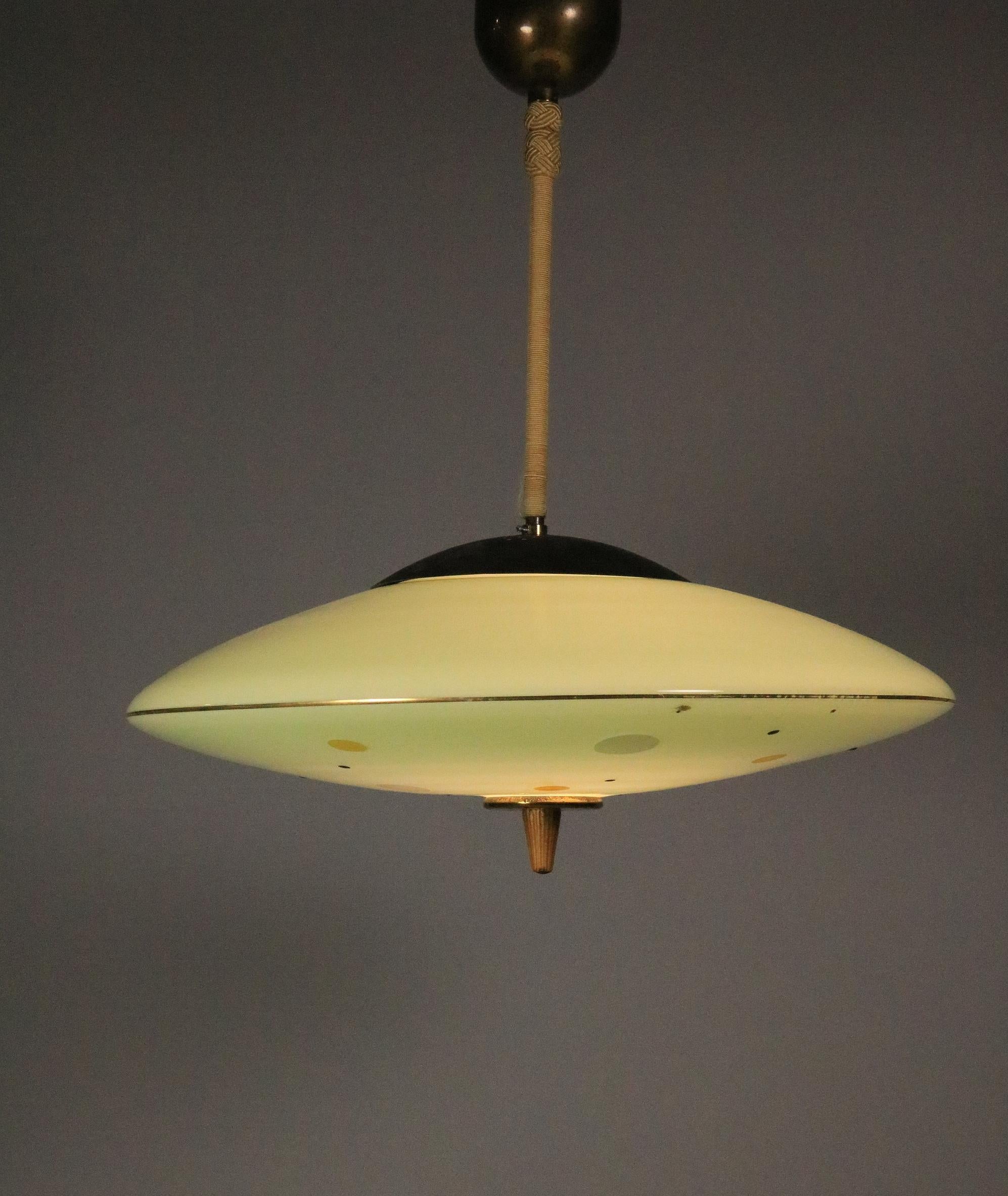 Beautiful mint green pendant lamp from the 1950s.
Decor on the bottom with dots.
 
Rod wrapped with cord.
 
Signs of use especially on the metal cover (metal darkened) and slightly color abrasion.
New wiring.
1 x E27 socket
 
Diameter: 45 cm / 17.72