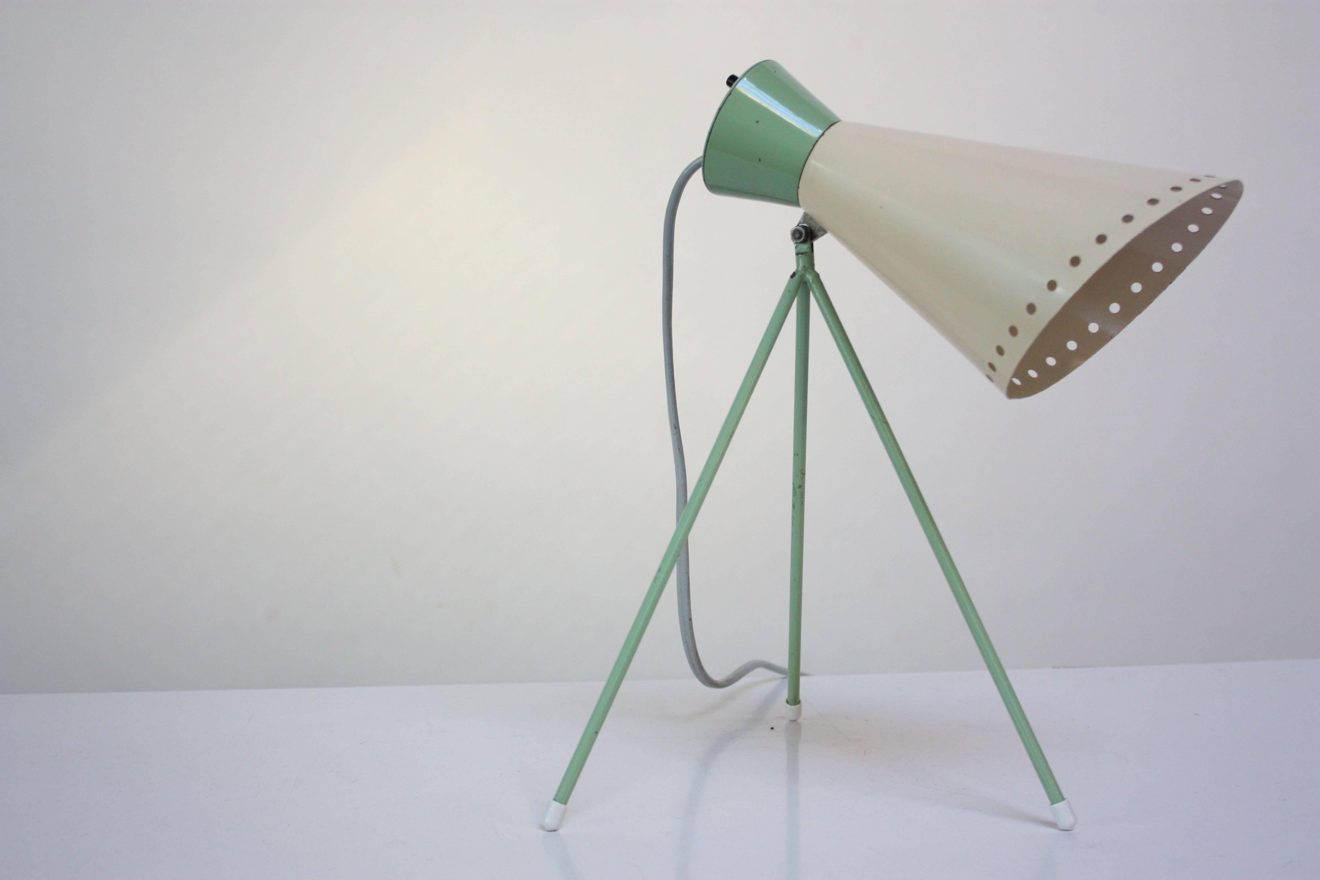 Czech table lamp designed in 1958 by Josef Hurka for Napako. Rare and early light mint green enameled tripod base with off-white perforated metal shade, which is fully adjustable. Remarkable, original condition with only faint wear. 
Single E14