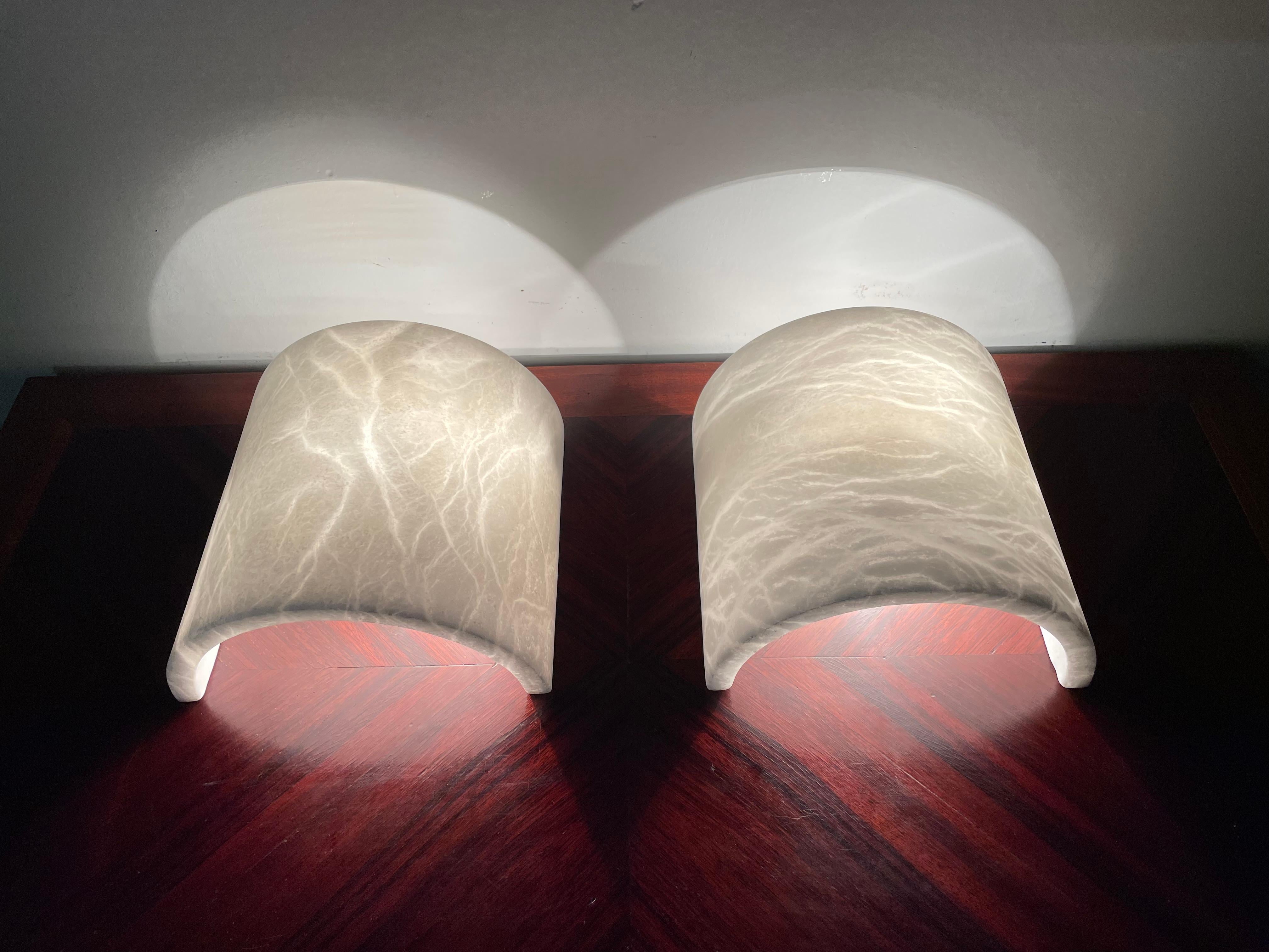 Handcrafted and truly stylish pair of midcentury alabaster fixtures with stunning vein patterns.

If you are looking for a great shape and practical size pair of sconces to grace your living space then these first class and pure white natural
