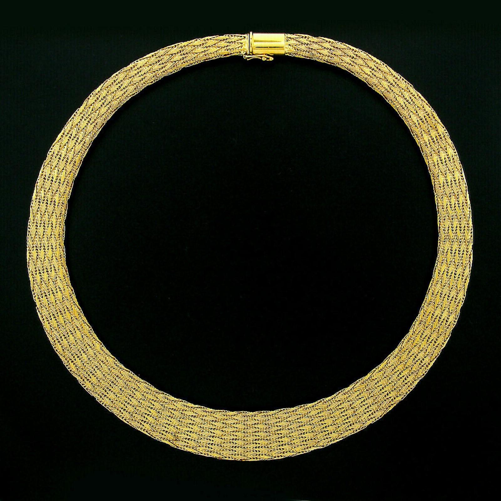 Here we have a 100% authentic early Roberto Coin necklace that was crafted in Italy from solid 18k yellow gold. It features a super smooth and neatly woven mesh design throughout. The chain gracefully graduates from approximately 7.25mm at the back