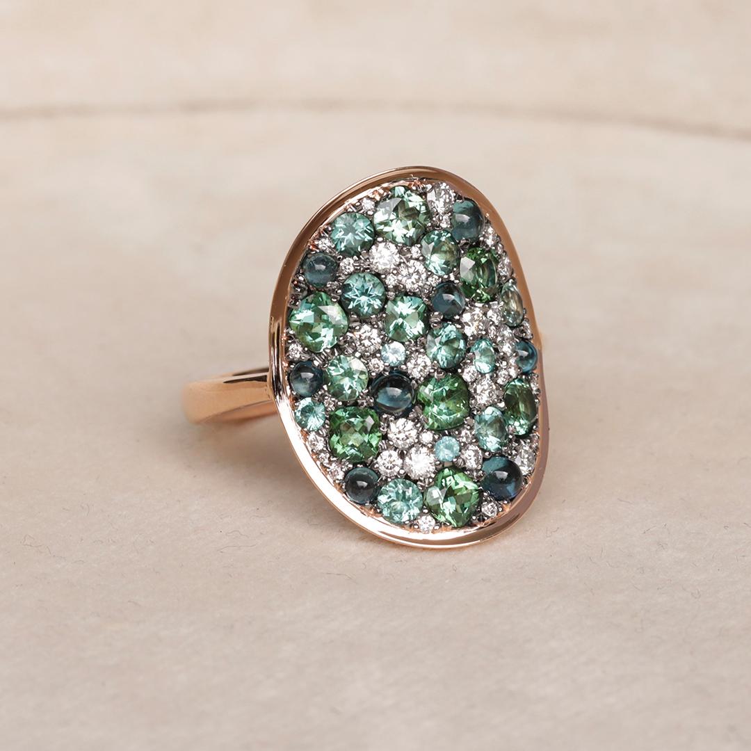 Experience the exquisite allure of this one of a kind highly detailed Tourmaline Ring, a true masterpiece meticulously crafted by Belgian jewellery artist Joke Quick. 

This extraordinary piece captures a stunning blend of blue and blue-green shades