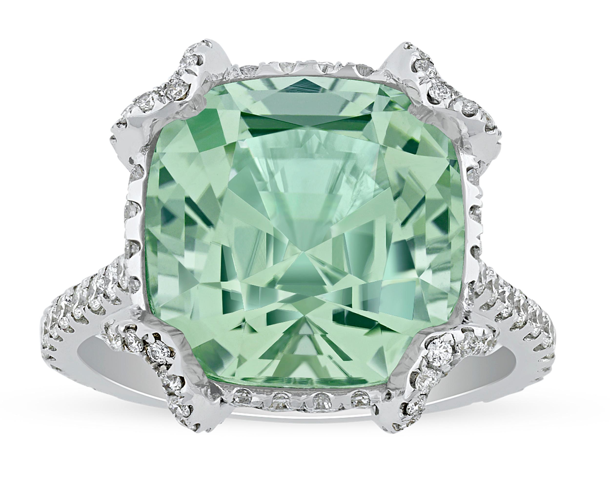 The refreshing and crisp green hue of mint tourmaline in this ring brings to mind the coming of spring. Weighing 8.36 carats, the square octagon-cut gemstone resides in an 18K white gold setting amongst a halo of white diamonds.