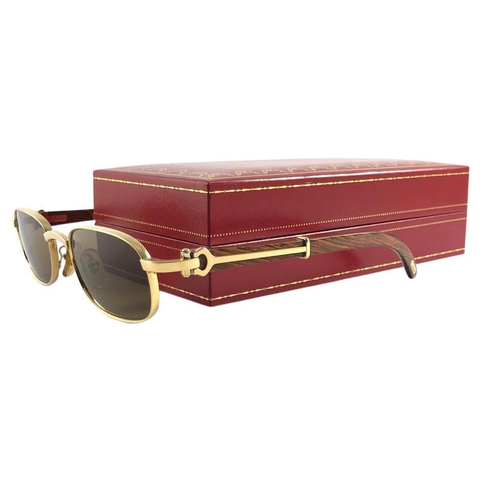Mint 1990 Cartier Full Set Camarat Hardwood Sunglasses with new solid brown  (uv protection) lenses. 
Frame is with the front and sides in white gold and has the famous wood & gold accents temples. 
Amazing craftsmanship! All hallmarks. Both arms