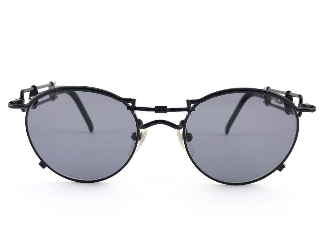 Vintage Jean Paul Gaultier 56 0174 schwarz  Details Rahmen. 
Dunkelgraue Gläser vervollständigen einen tragbaren JPG-Look.

Erstaunliches Design mit starken, aber raffinierten Details.
Dieser Artikel hat sichtbare Abnutzungserscheinungen auf dem