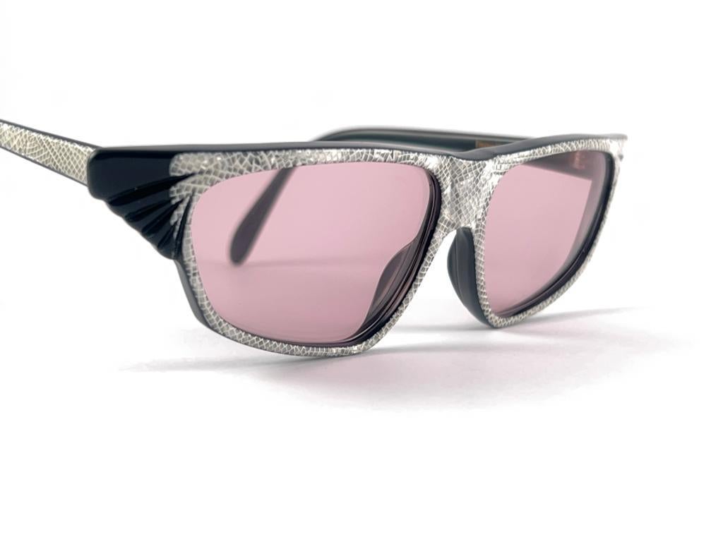 

Mint Super 1980'S Lacquered Michele Lamy Holding A Pair Of Light Pink Lenses
This Item May Show Minor Sign Of Wear Due To Storage.
It Has A Small Defect On The Right Temple Hardly Noticeable While Wearing, Please Study The Pictures Before