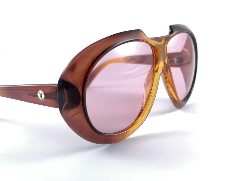 Mint Vintage Playboy Optyl amber ombre frame sporting spotless light rose lenses. 

Made in Germany.
 
Produced and design in 1970's.

This item show minor sign of wear due to storage on the frame.

FRONT  : 15 cms 
LENS HEIGHT : 5.5 CMS
LENS WIDTH