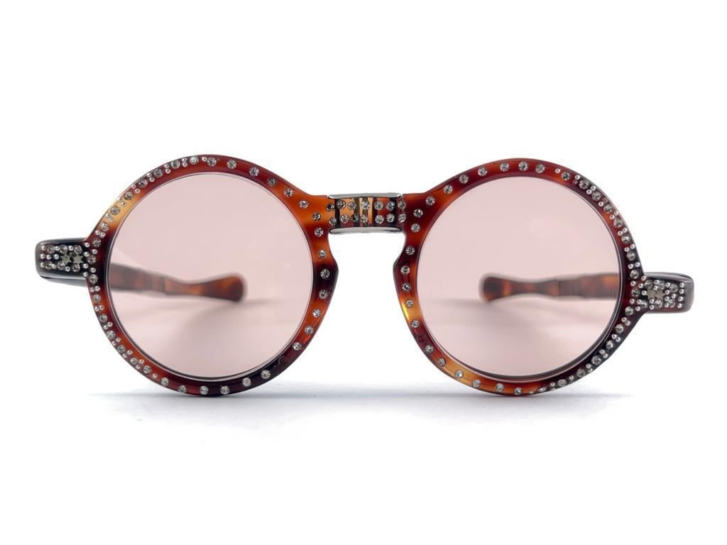 Mint Rare pair of round medium Tortoise feel with rhinestones frame holding pair of light pink lenses.  

Super delicate ornamented foldable frame. 

Please notice this item may show minor sign of wear 



Made in France



Front                    