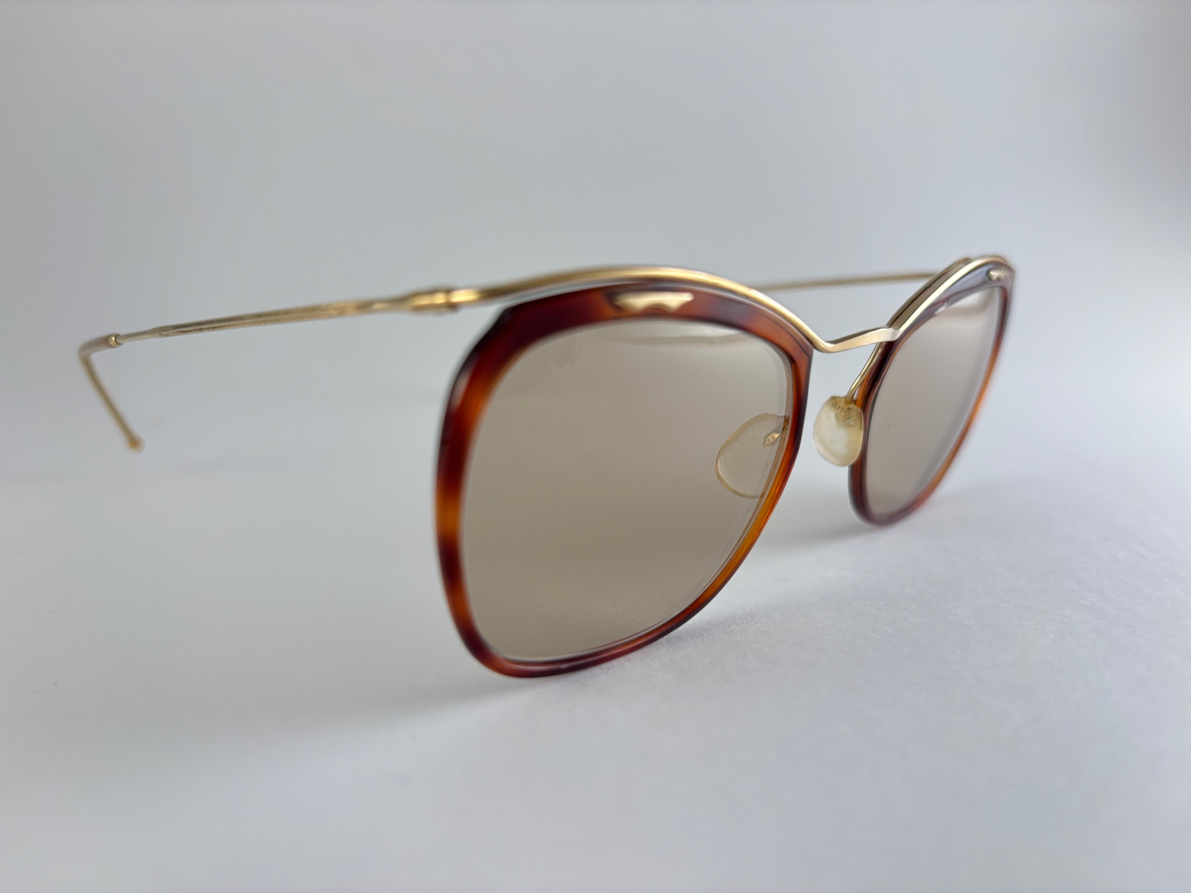 
Ultra Rare Collectors Pair of Vintage signiert Amor Small Tortoise & Gold Akzente 1960'S Sonnenbrillen
Leichter Rahmen mit hellbraunen Gläsern.
Dieses Paar zeigt sichtbare Abnutzungserscheinungen an Gläsern und Rahmen aufgrund von mehr als 60