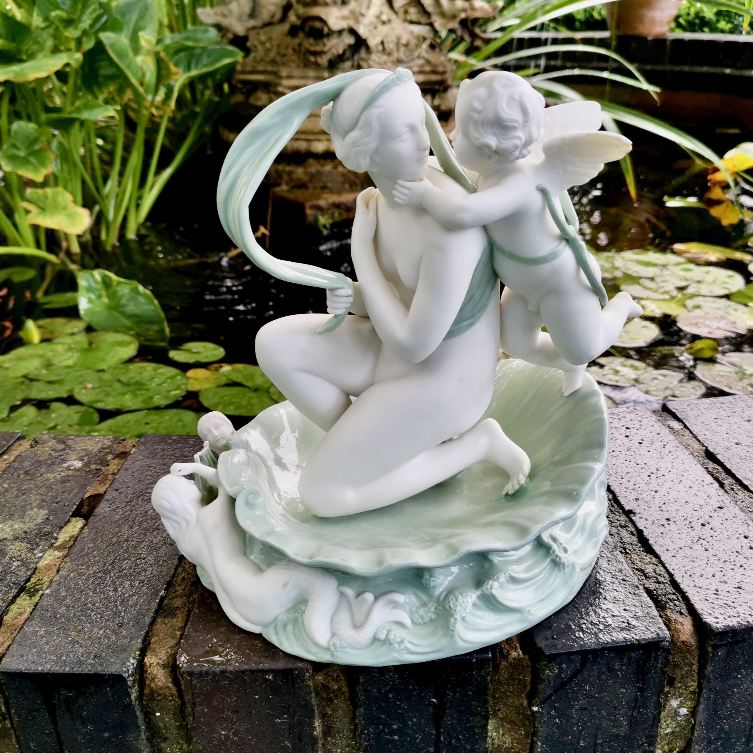 This is a beautiful celadon parian porcelain figure group made by Minton in 1861, which was the Victorian era. The group is of Venus and her son Cupid, seated in a shell.

Minton was one of the pioneers of English china production alongside other