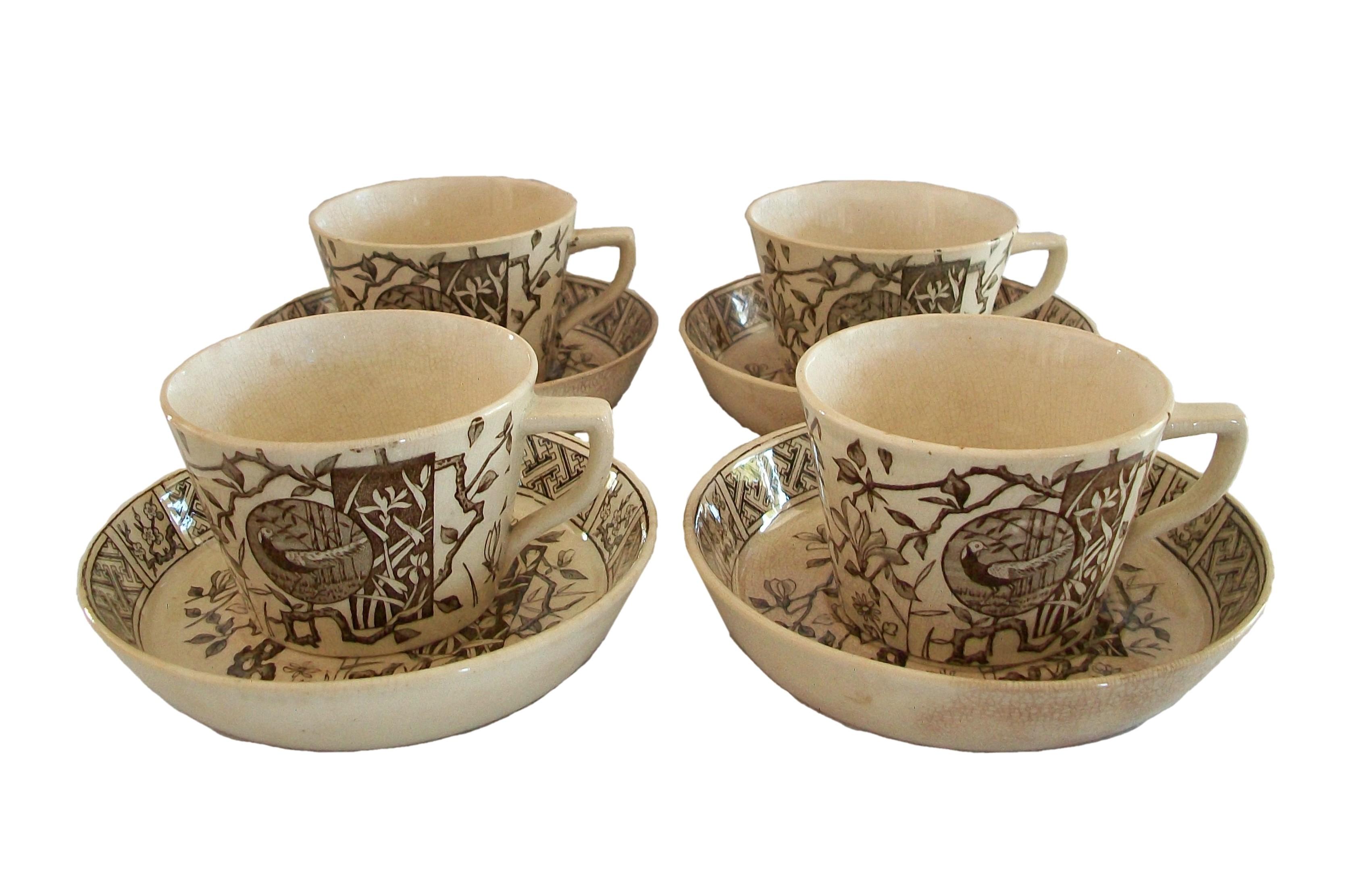 MINTON - 'Faisan' - Rare antique Aesthetic Movement ceramic tea cups and saucers - set of four - transfer decorated in brown on a cream ground - elaborate 'Japonesque' decoration featuring panels with birds and flowers - each piece signed on the