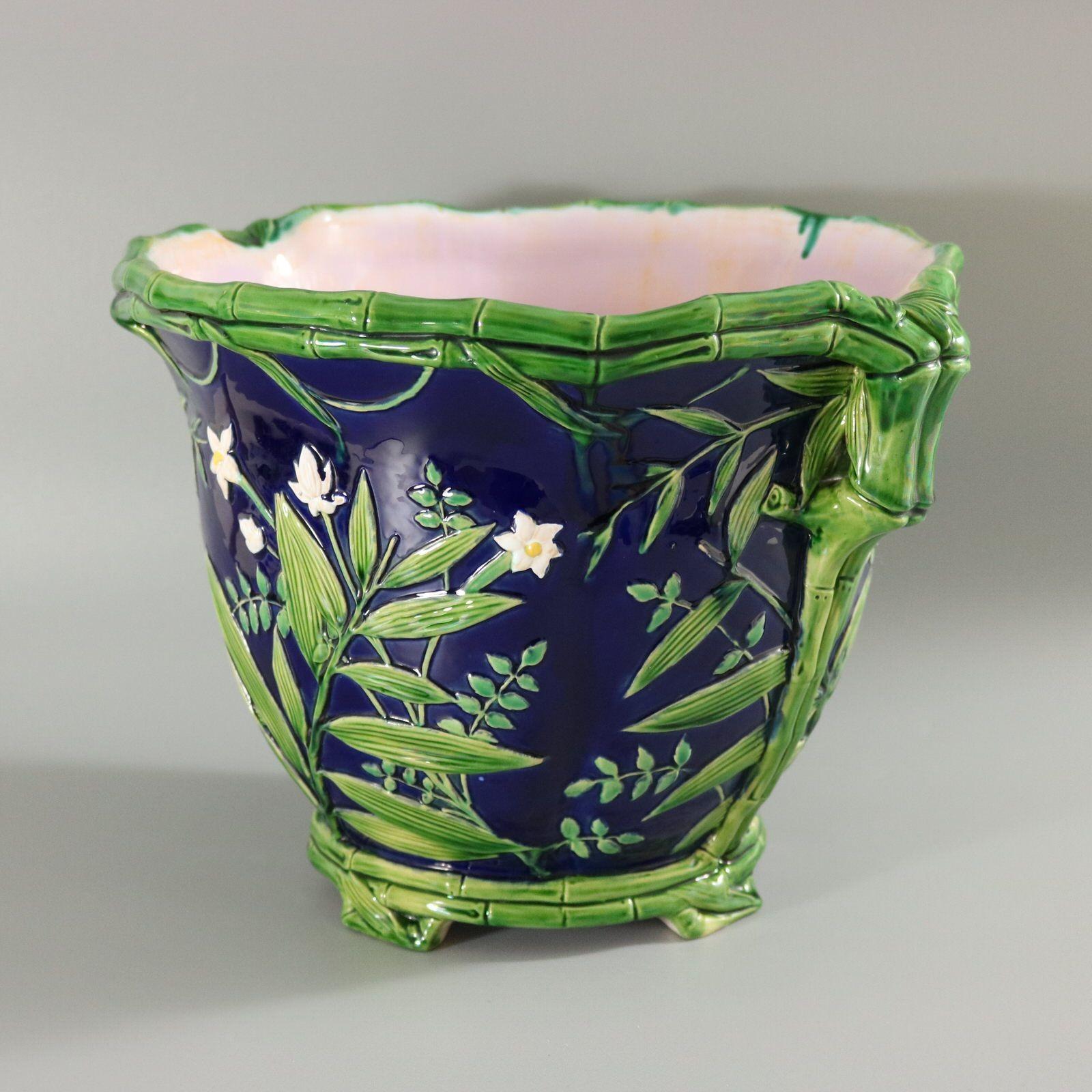 Minton Majolica jardinière which features bamboo branches, leaves and flowers. Cobalt blue ground version. Colouration: cobalt blue, green, white, are predominant. The piece bears maker's marks for the Minton pottery. Marks include a factory