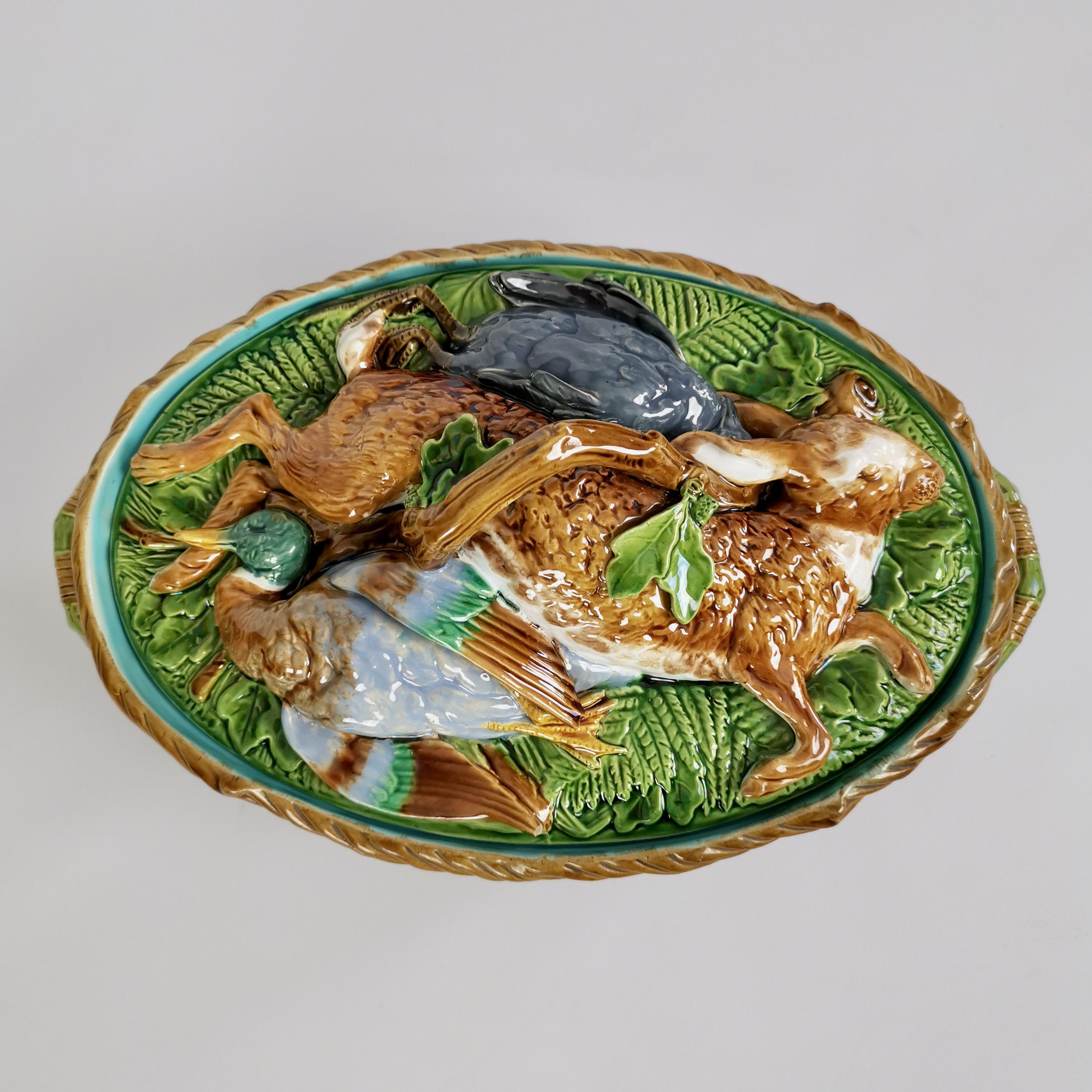 This is a stunning game pie tureen with cover made by Minton in 1881. The piece is made of majolica and has realistically relief-moulded game on the cover: a rabbit, a mallard and a pigeon.
 
This tureen would make a wonderful centre piece to a