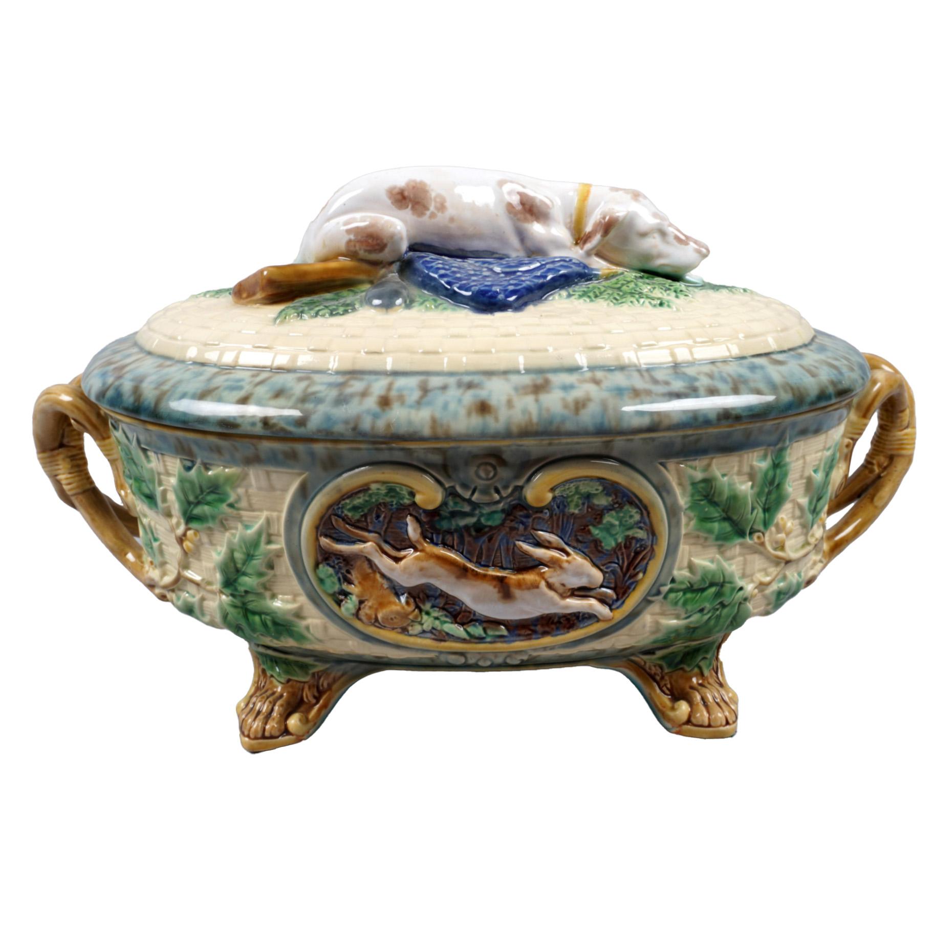 This late 19th-century Minton majolica game pie tureen and cover offer a glimpse into the richness of Victorian dining. The cover features a meticulously molded hunting dog nestled amidst ferns, evoking scenes of countryside pursuits. The