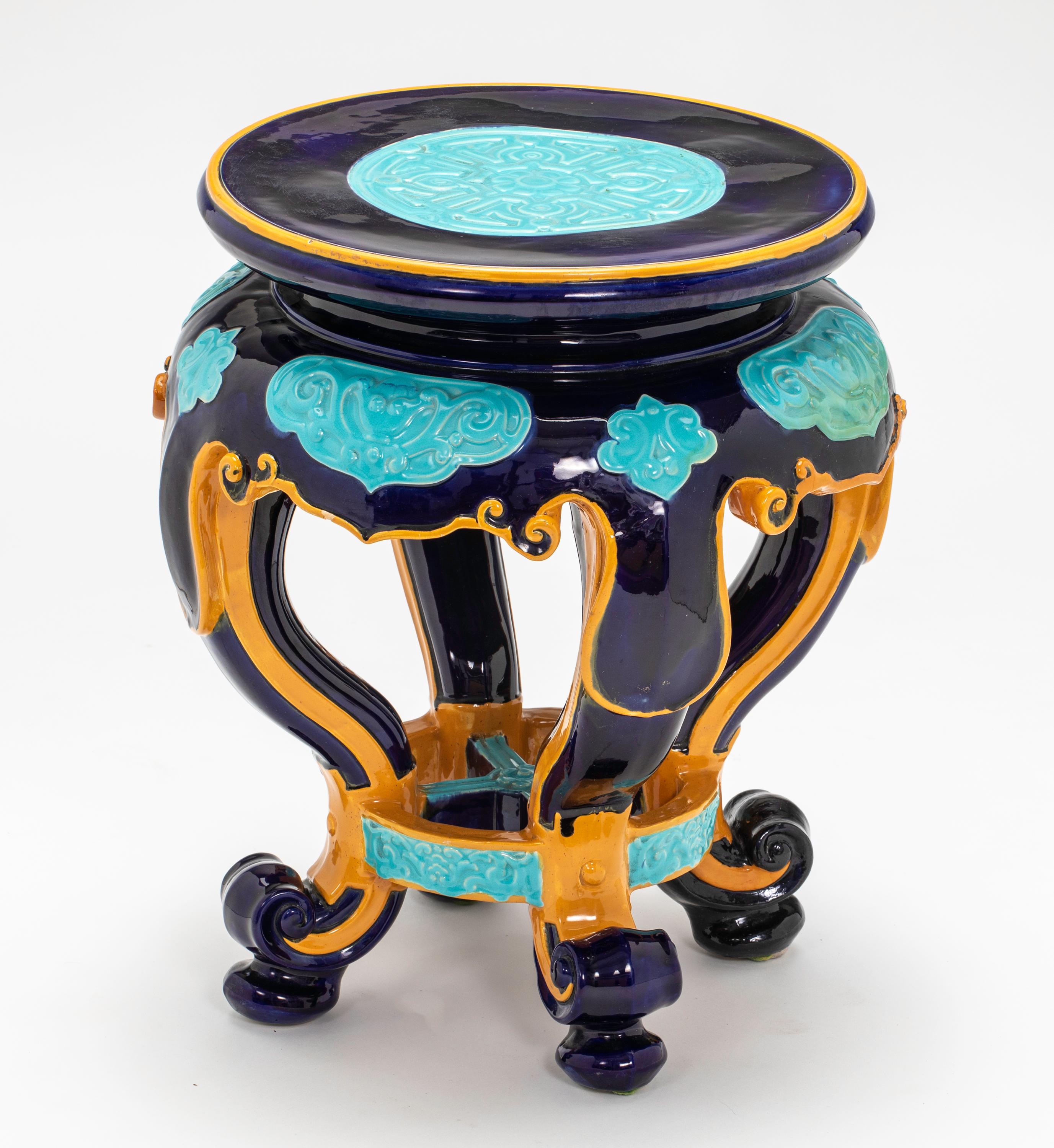 English Minton Majolica garden stool. Circular ceramic stool in colorful coloration of turquoise, cobalt blue and gold glaze. Styled in shaped aprons and four cabriole legs. Impressed Minton Mark, circa 1870.
Two very small old flea chips.