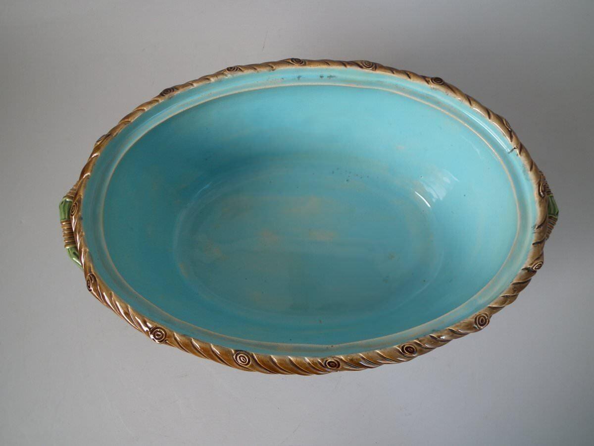 Minton Majolica game pie dish which features a hare, mallard and blackbird on a bed of fern and oak leaves. Colouration: brown, green, turquoise, are predominant. Bears a pattern number, '9'.