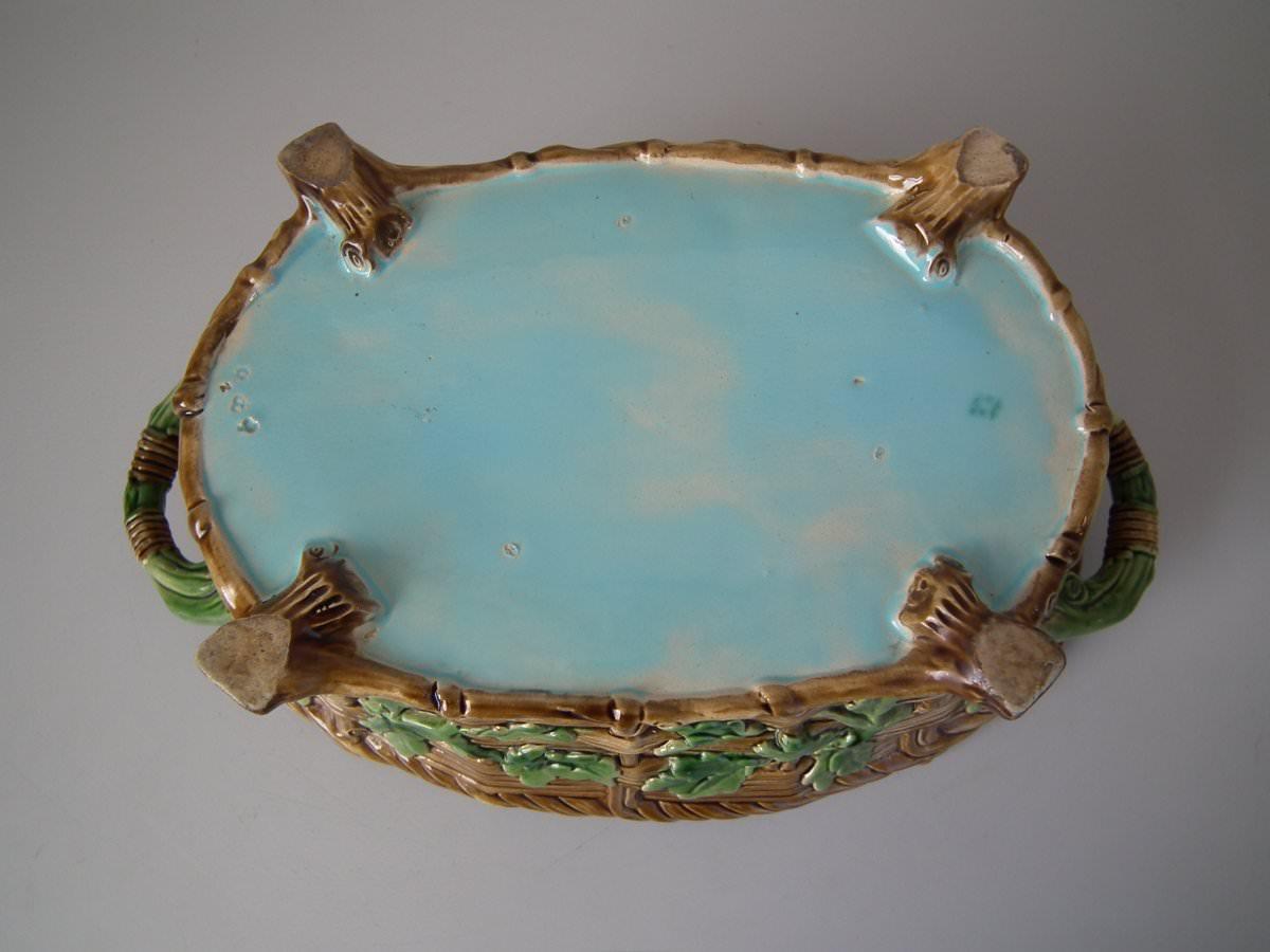 Minton Majolica game pie dish with liner which features a hare, mallard and blackbird on a bed of fern and oak leaves. Coloration: brown, green, turquoise, are predominant. The piece bears maker's marks for the Minton pottery. Marks include a