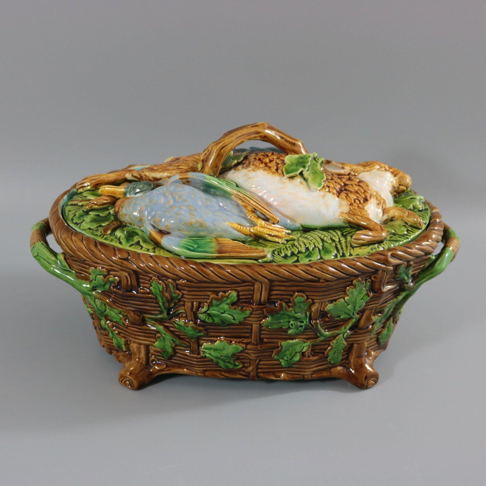 Minton Majolica game pie dish with liner which features a hare, mallard and blackbird on a bed of fern and oak leaves. Colouration: brown, green, white, are predominant. The piece bears maker's marks for the Minton pottery. Bears a pattern number,