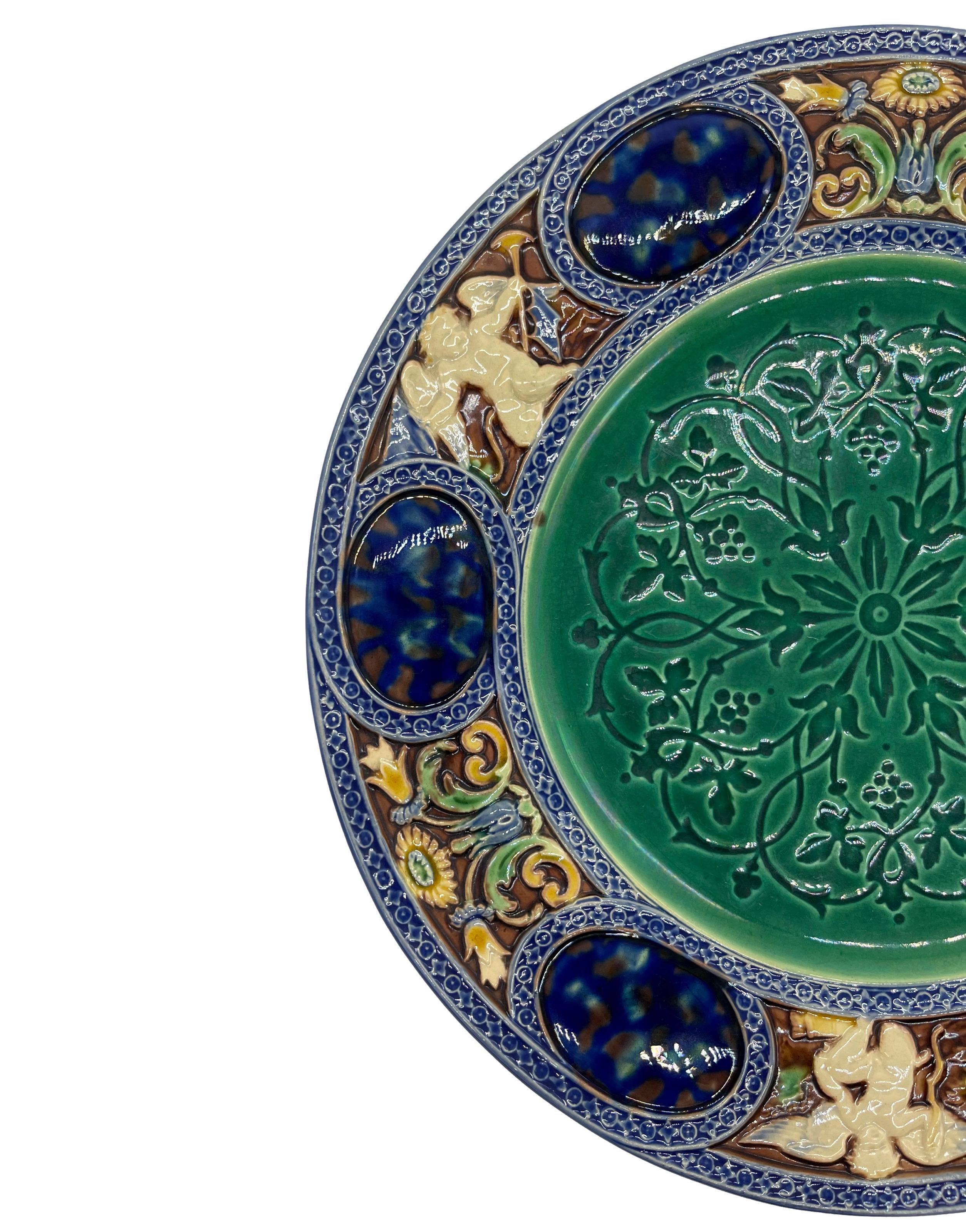 Minton Majolica Cabinet Plate, with a central medieval design in émail-ombrant, a difficult technique achieved by flooding majolica glazes over an intaglio design, causing the impressed cavities to appear as shadows of various depths; bordered with