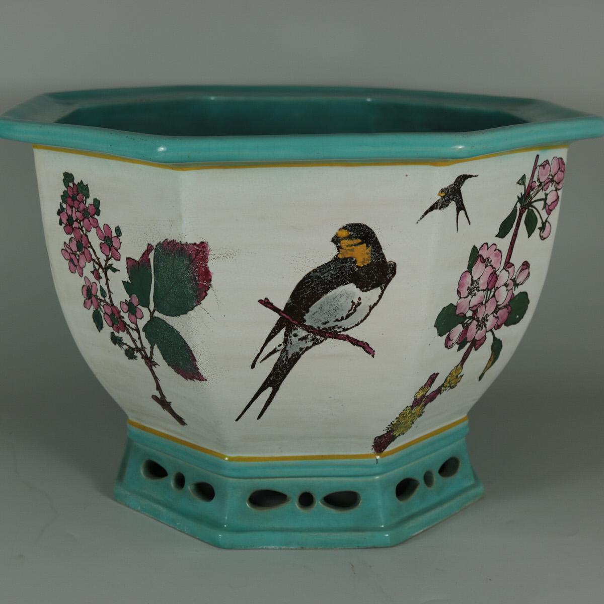 Minton Majolica jardinière which features illustrated flora and fauna, including: a partridge, corn & barley, swallows, a bee, a bullfinch on a blossoming branch and flowers. Artist and designer, William Stephen Coleman, was paid £200 by Minton for