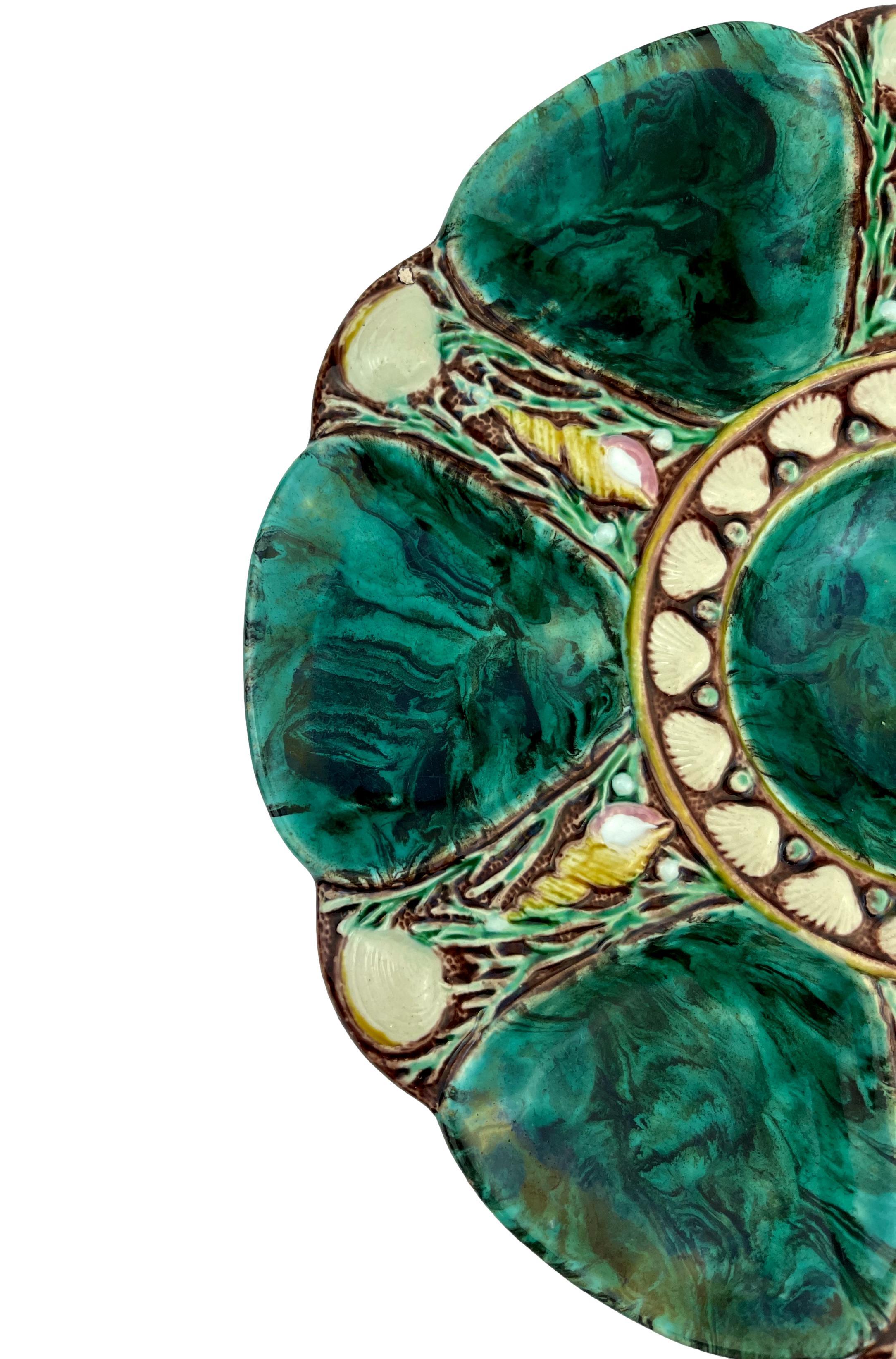 Minton majolica six-well oyster plate glazed in simulated malachite, the reverse with impressed and molded marks: 'MINTON,' and Minton Date Cypher for 1873, molded British Registry Lozenge for 1867, the year the design was registered, and impressed