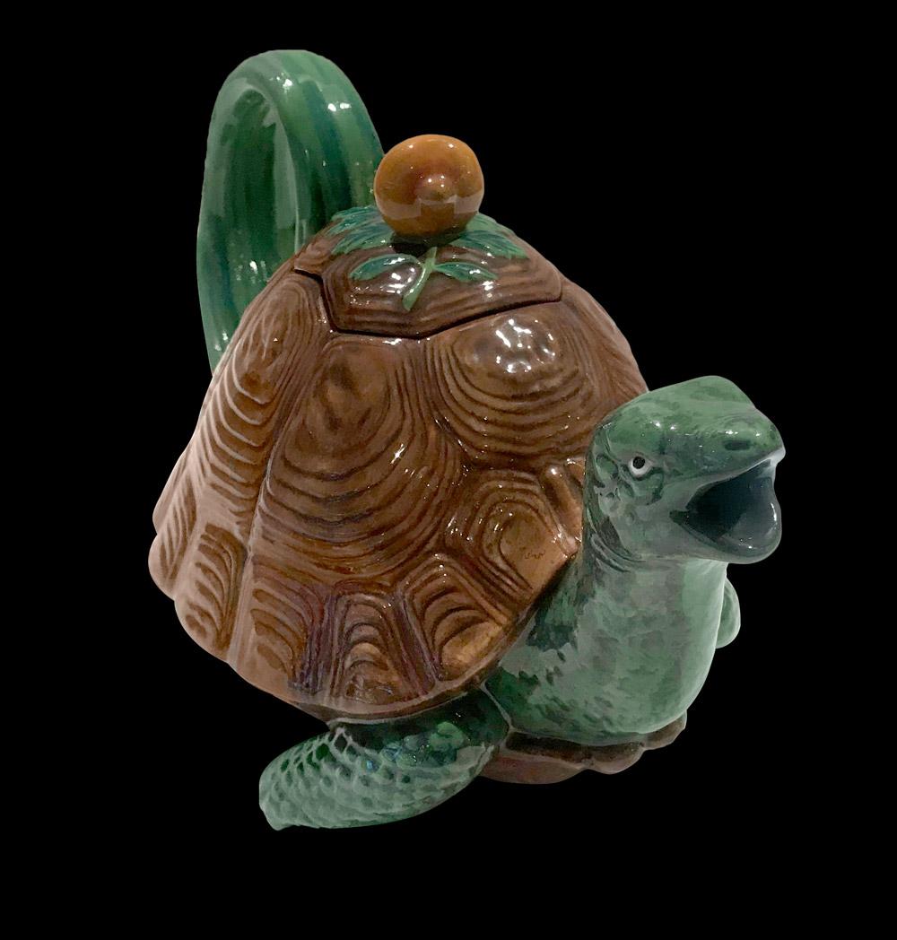 Tortoise Majolica Teapot, with its head protruding from the shell to form the spout, the tail making a handle, the cover with an orange shell knop resting on seaweed. 

Reedition of a famous Minton majolica production circa 1870. Limited and