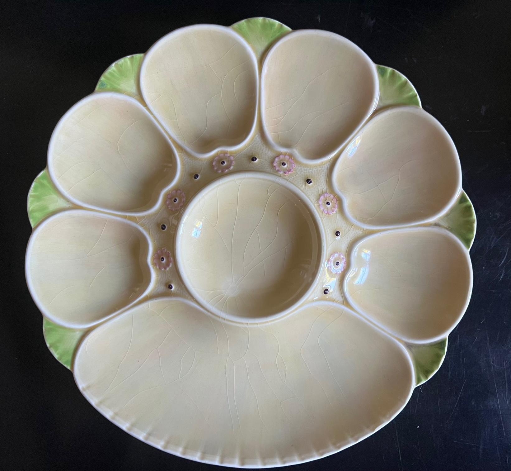 Cream colored oyster plate with a multi colored luster glaze, pink flowers and green tips was made in England by Minton around 1900. The plate has six oyster wells, a center lemon or sauce well and a larger well for lemons or crackers.

This back