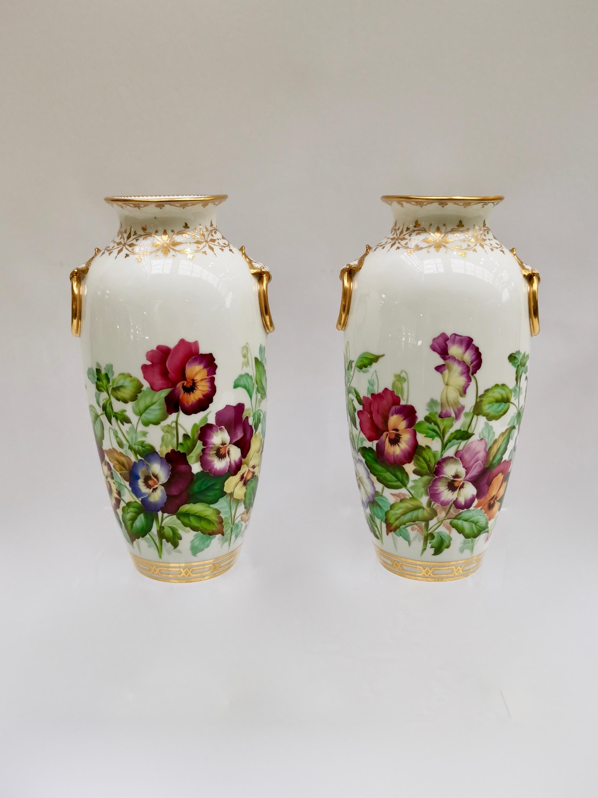 This is a spectacular set of two porcelain vases made by Minton in 1853, which was the Victorian era. They are beautifully hand painted with pansies (or violets) by the famous painter Jesse Smith.

Minton was one of the pioneers of English china