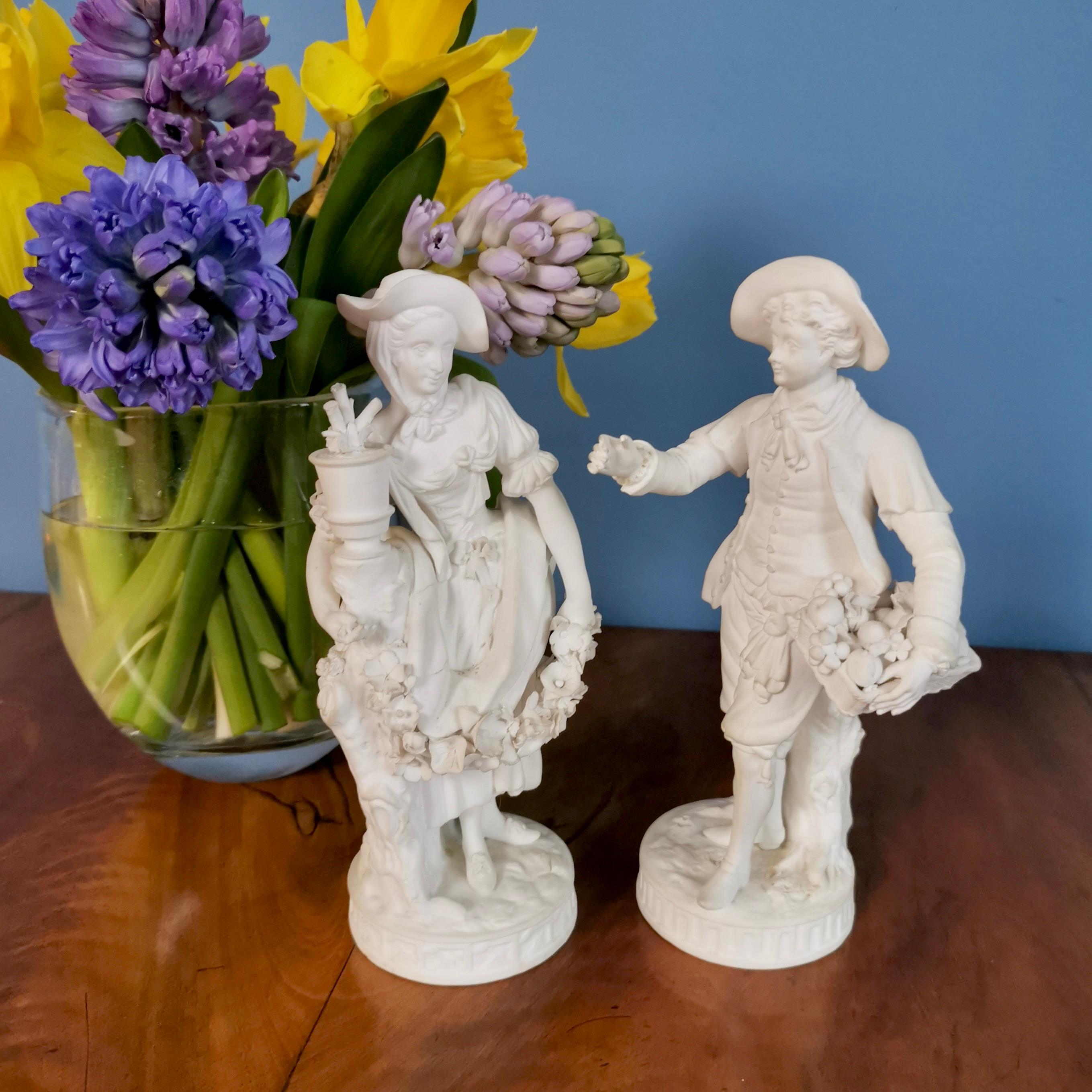 This is a very charming pair of white biscuit figures made by Minton in around 1835. The pair is actually a near-pair: the gentleman is a gardener with a basket of fruit, the lady has a garland of flowers and they each actually belonged to different