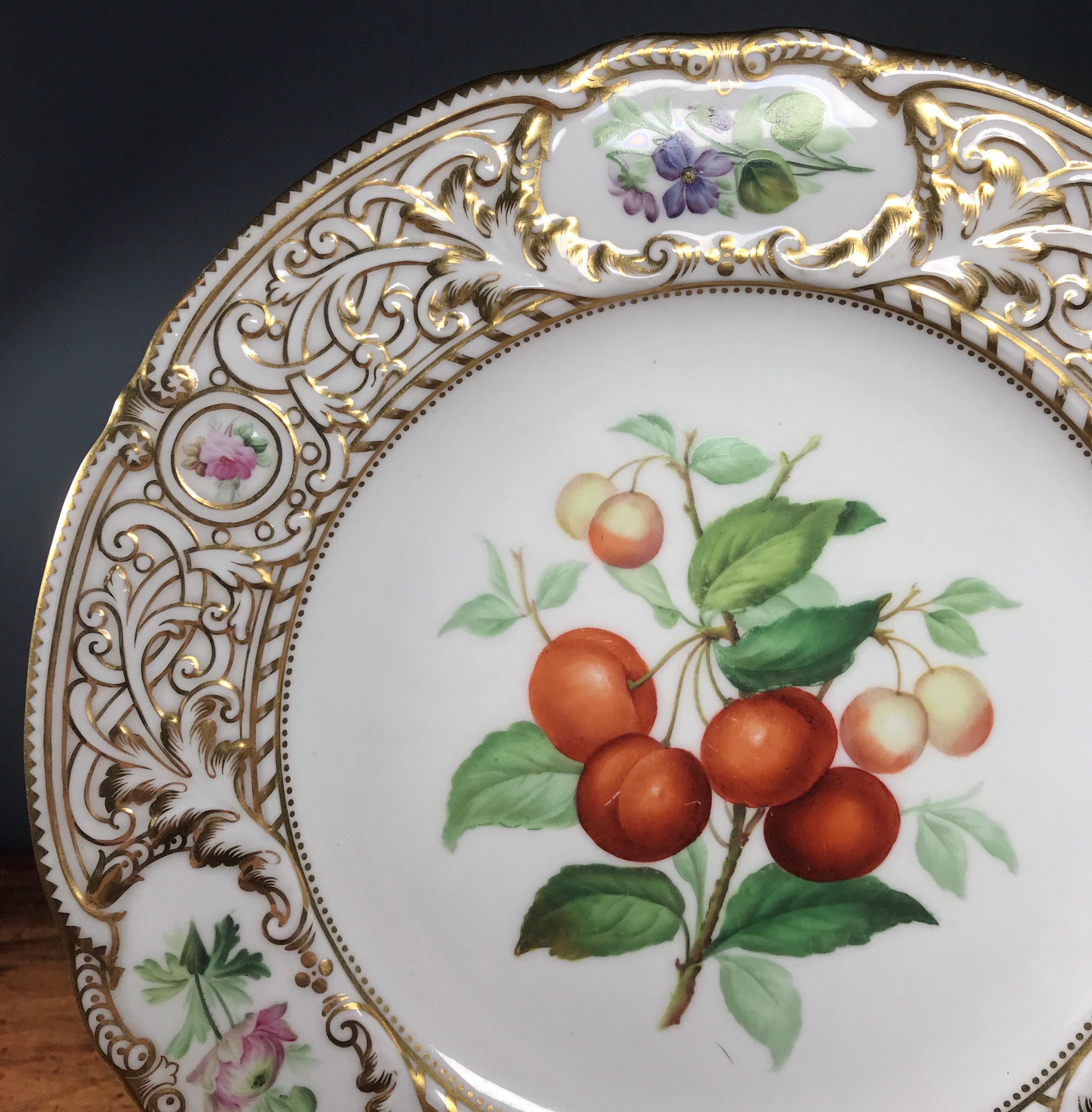 A fine Minton plate, the rim strap-work moulding picked out in rich gold, the center with a large specimen of cherries, with further flower specimens in the reserves on the border, titled to the back 'Cherries'. 

Impressed date code for 1852.