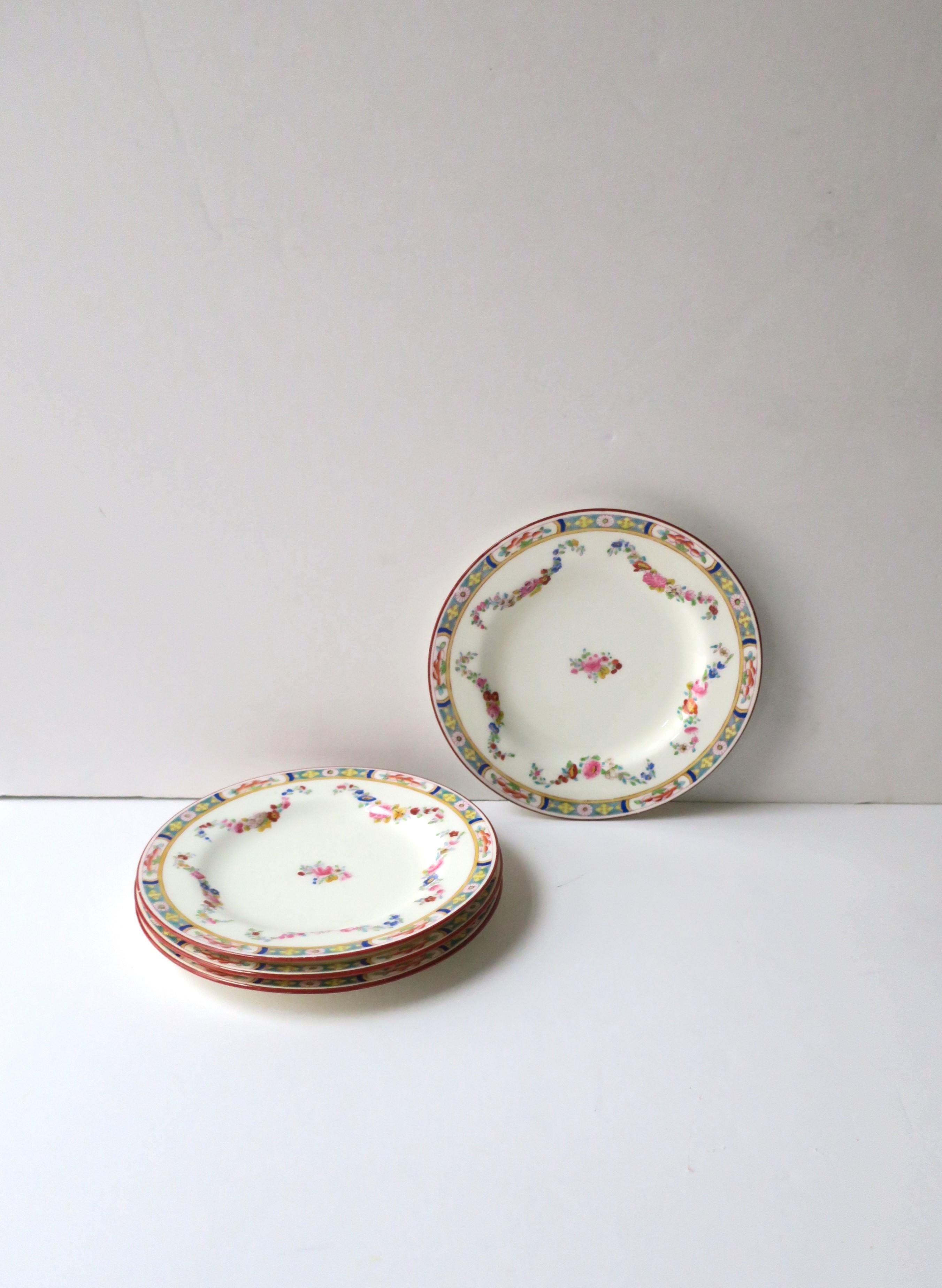 A rare set of four (4) English Minton porcelain plates, circa early-20th century, England. Plates were made exclusively for Rhodes Bros. Tacoma department store which opened in 1903, Tacoma, Washington. In addition to the beautiful flower and leaf