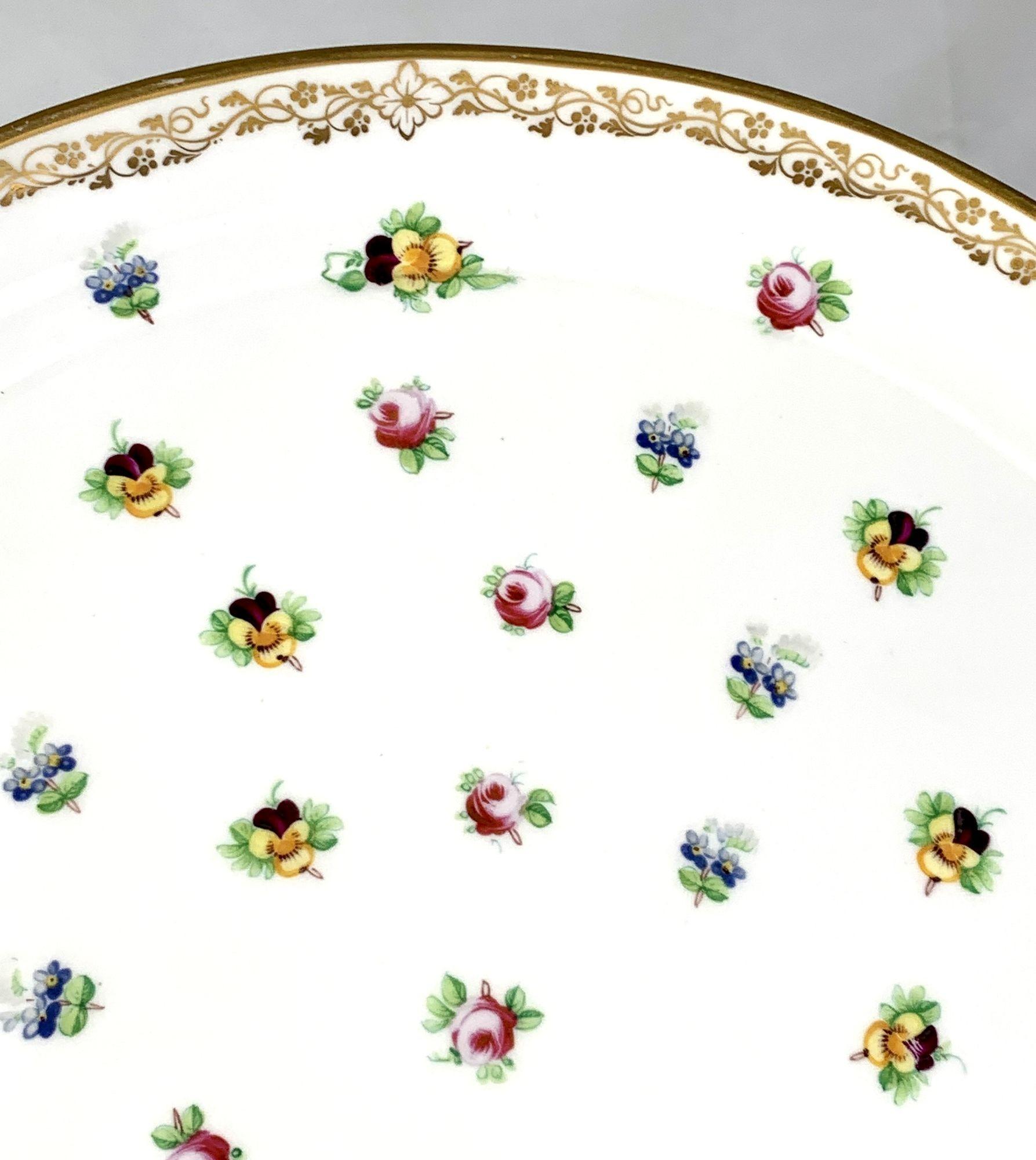This is the perfect serving platter for cool drinks in the garden on a summer's day.
Made by Minton circa 1840, the platter shows delicate roses, forget me knots, and pansies scattered about.
The roses are a lovely pink, the pansies the expected